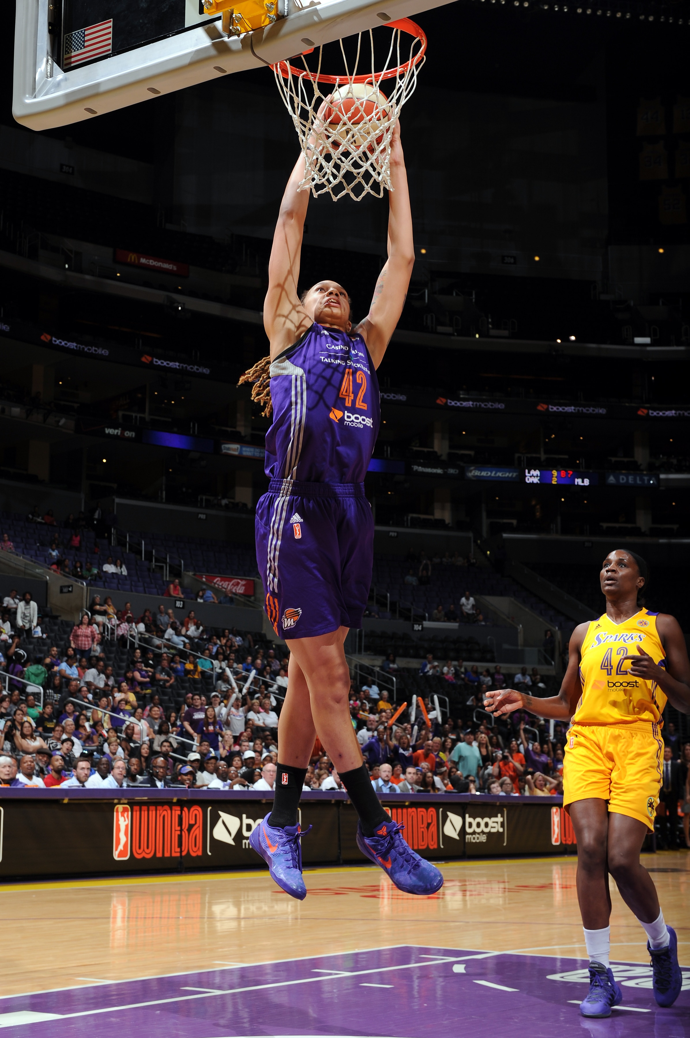 LOS ANGELES, CA - AUGUST 24: Brittney Griner #42 of the Phoenix Mercury dunks the ball as Jantel Lavender #42 of the Los Angeles Sparks looks on in Game Two of the Western Conference Semifinals during the 2014 WNBA Playoffs on August 24, 2014 at STAPLES Center in Los Angeles, California. NOTE TO USER: User expressly acknowledges and agrees that, by downloading and or using this photograph, User is consenting to the terms and conditions of the Getty Images License Agreement. Mandatory Copyright Notice: Copyright 2014 NBAE (Photo by Juan Ocampo/NBAE via Getty Images)