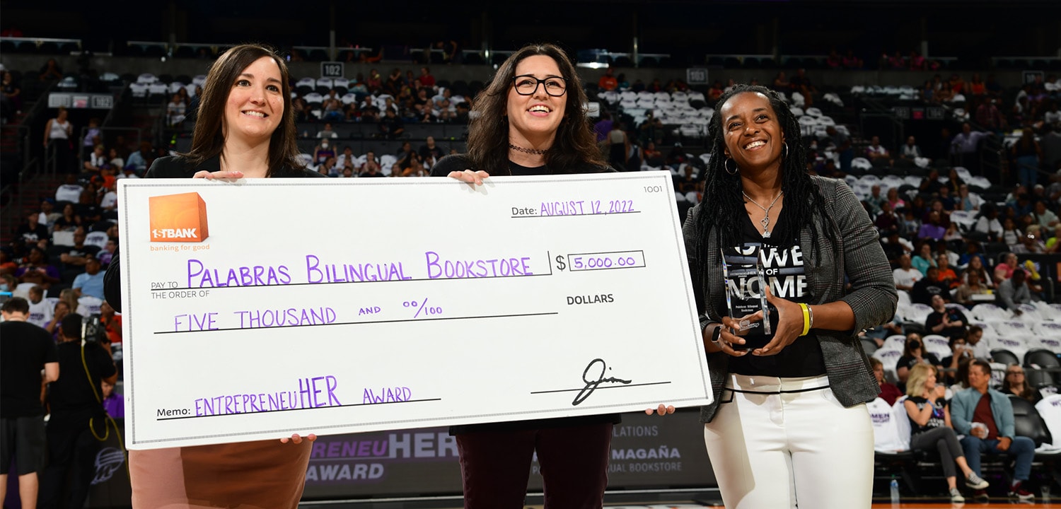 Rosaura’s friend, Celina Osuna, accepting the EntrepreneuHER award on her behalf at Friday’s Inspiring Women Night at Footprint Center