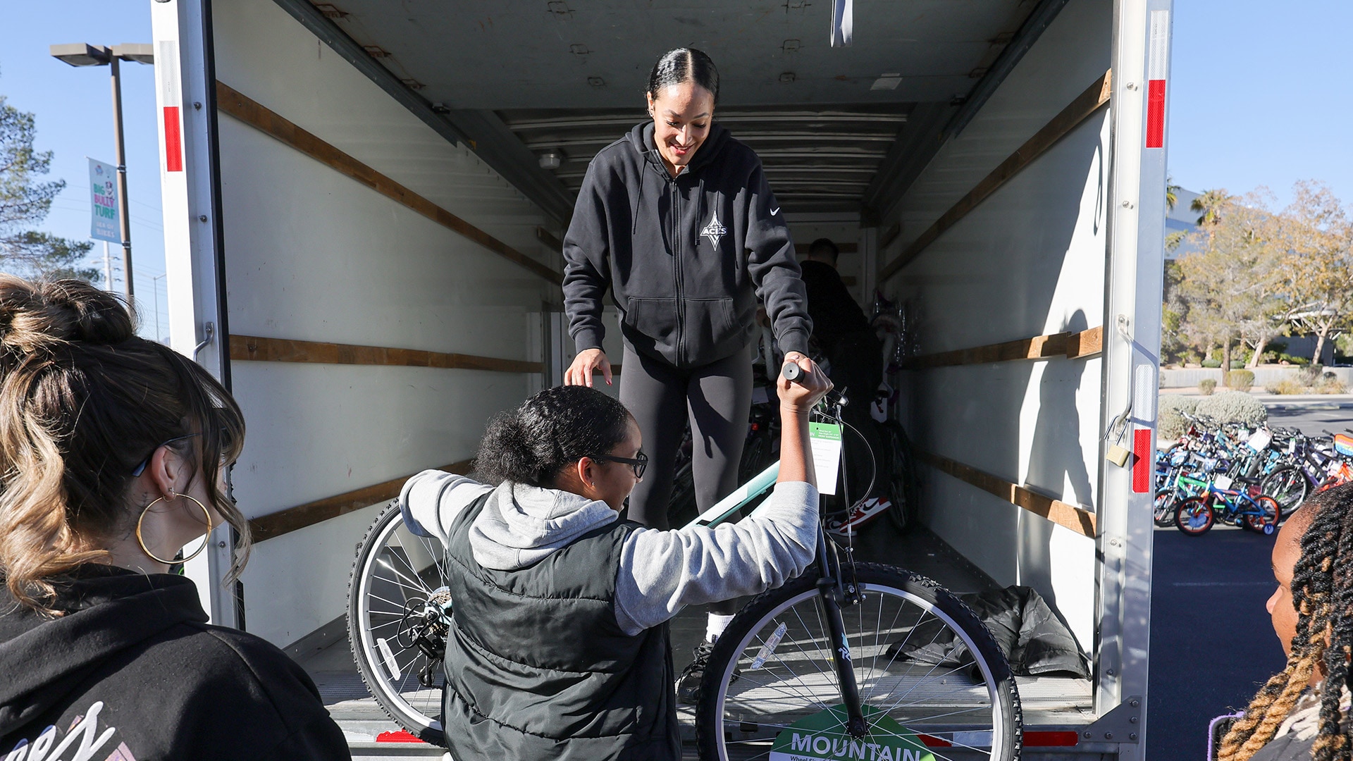 Aaliyah Nye helps unload the bikes