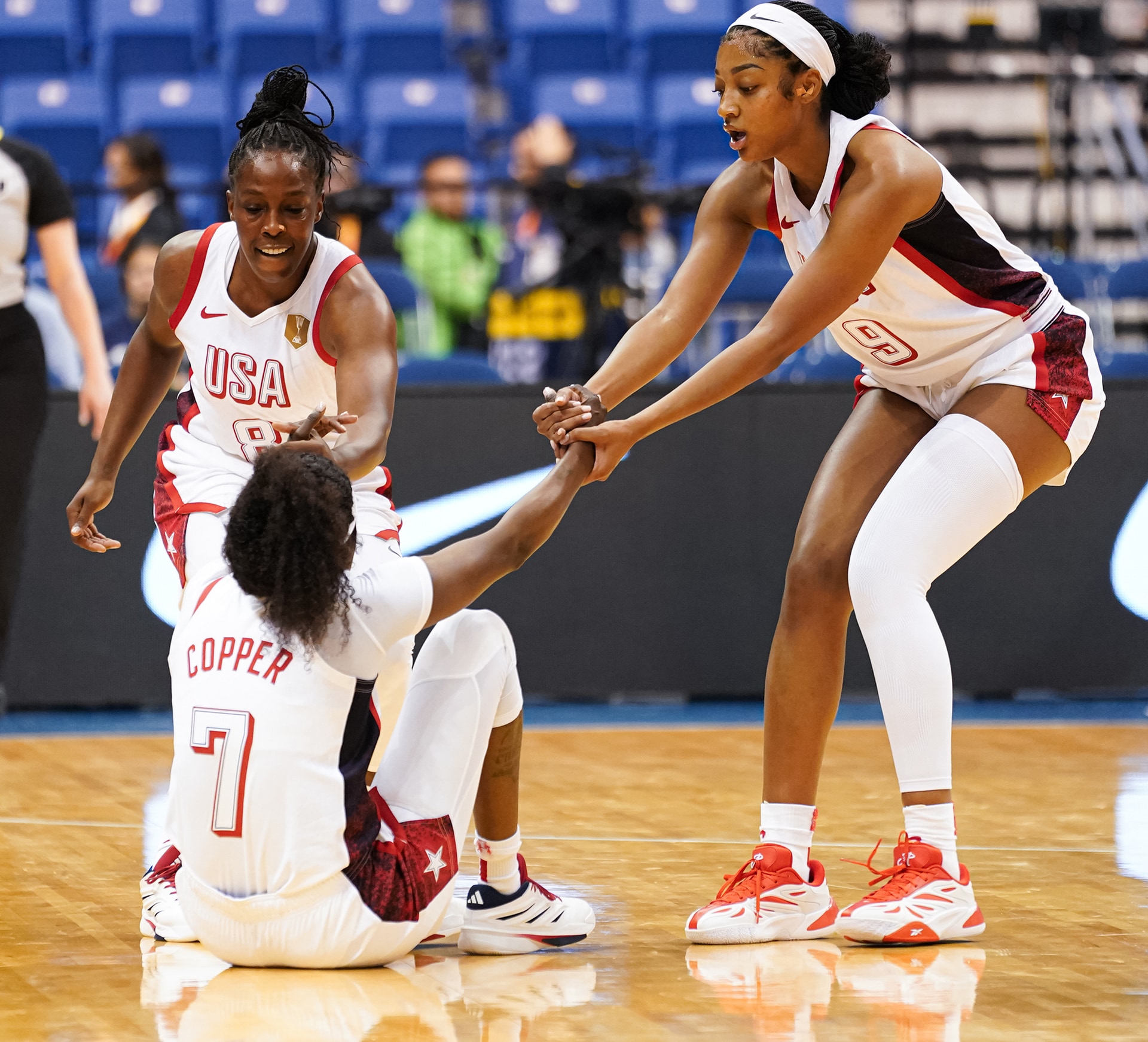 Chelsea Gray and Angel Reese picke up Kahleah Copper in a game against Senegal