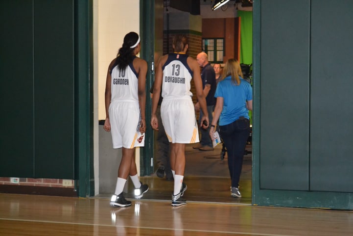 Chelsea Gardner (#10) and Alicia DeVaughn (#13) walking through a doorway on their way to media obligations.