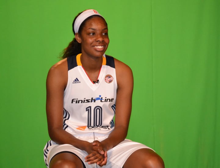 Chelsea Gardner (#10) smiles for a photo in front of a green screen.