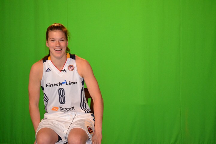 Maggie Lucas (#8) smiles in front of a green screen at Indiana Fever Media Day.