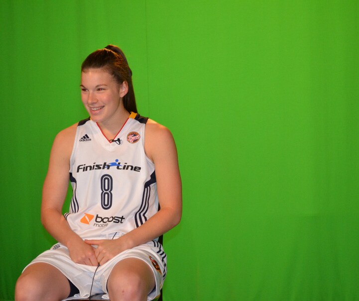 Maggie Lucas (#8) smiles in front of a green screen at Indiana Fever Media Day.