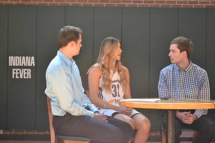 Jeanette Pohlen (#32) talks with two men from feverbasketball.com at a table during Indiana Fever Media Day.