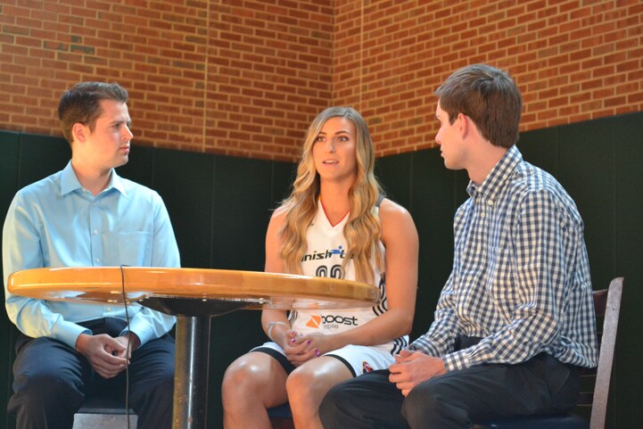 Jeanette Pohlen (#32) talks with two men from feverbasketball.com at a table during Indiana Fever Media Day.
