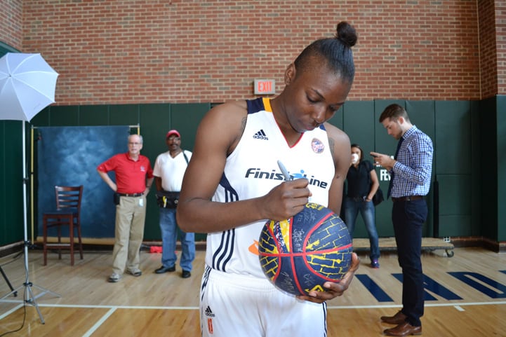 Tyaunna Marshall signs a Fever basketball during Indiana Fever Media Day.