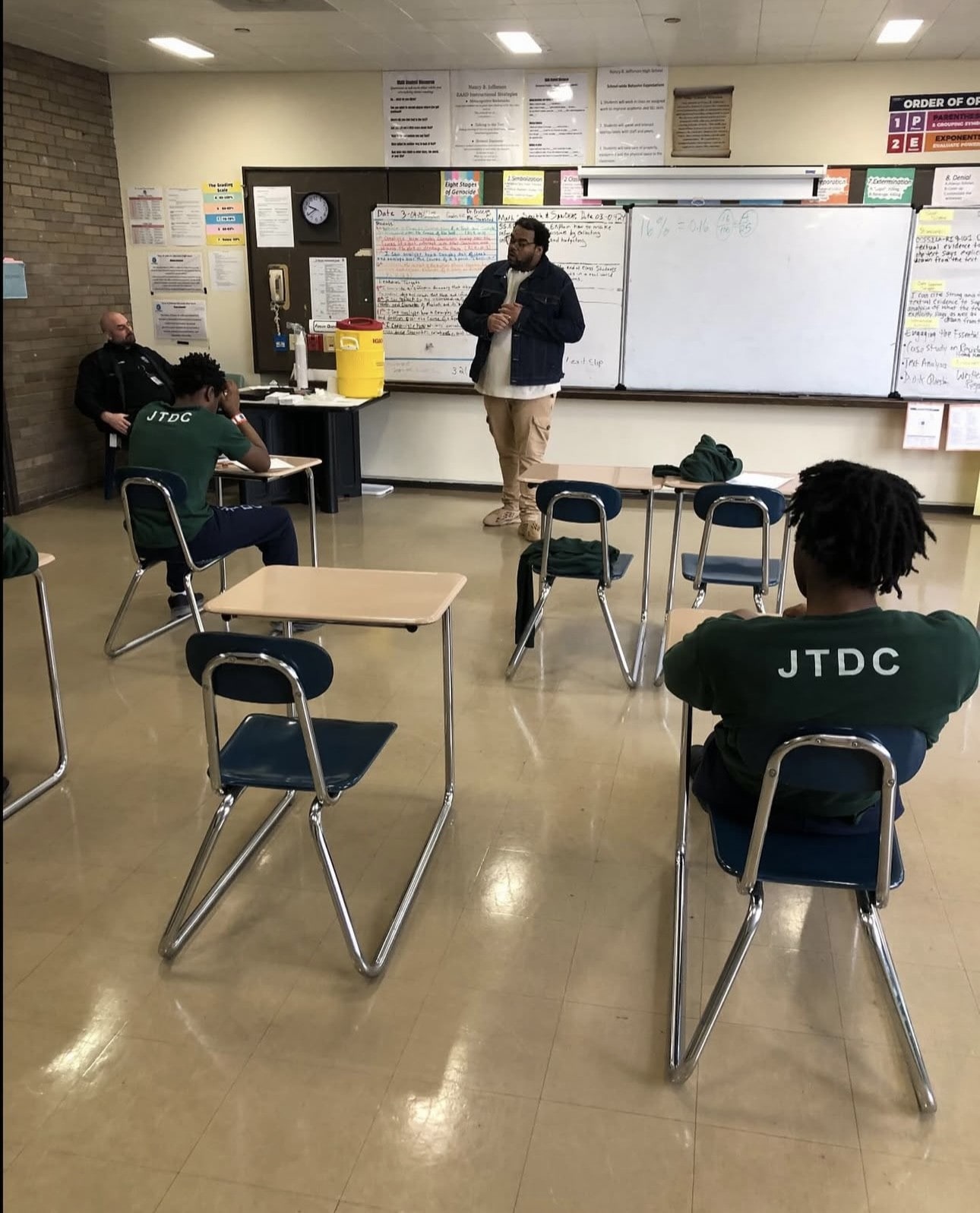 Chicago Sky Foundation Community Engagement Manager speaking with make youth at the Juvenile detention center.