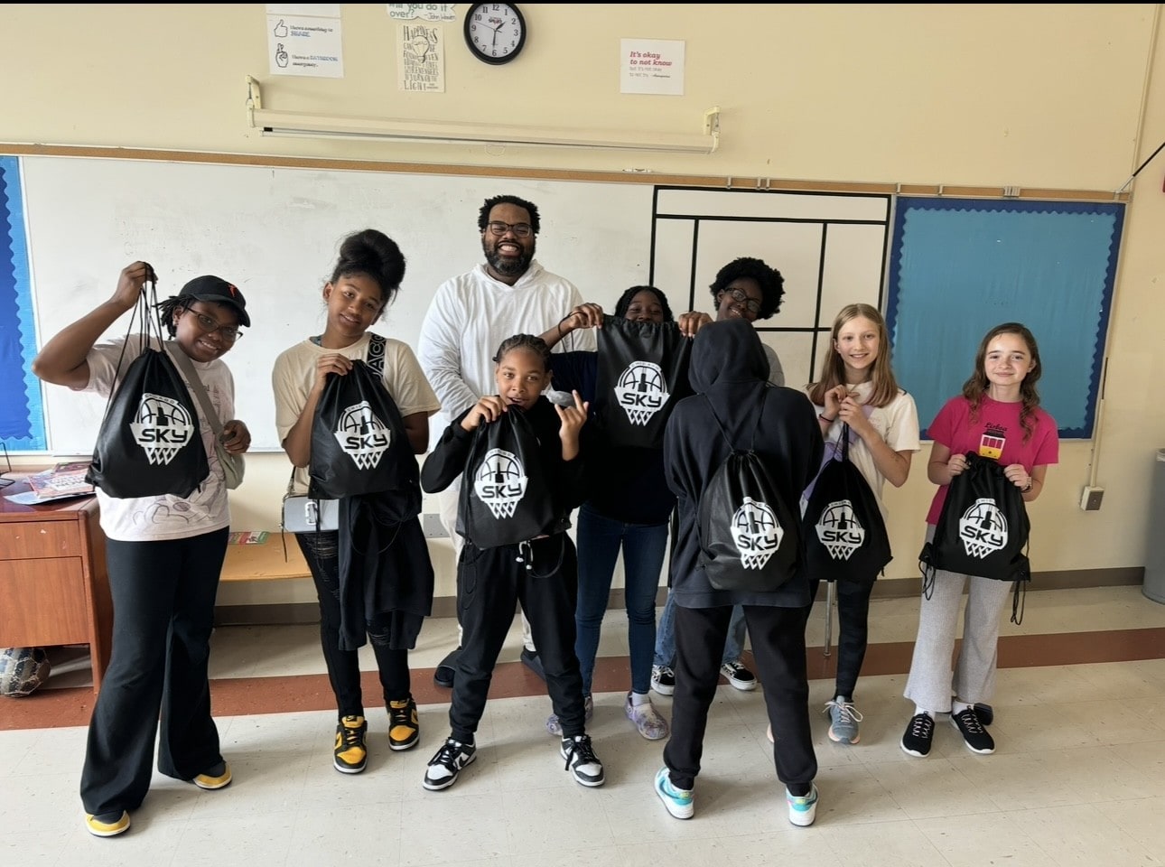 Sharing the importance of Title IX with some of the members National Teachers Academy girls basketball team.