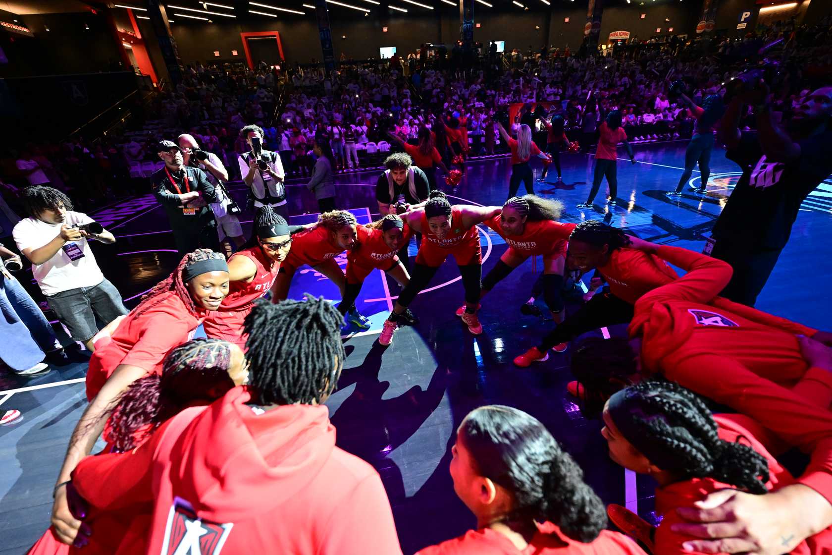 Atlanta Dream basketball team huddled