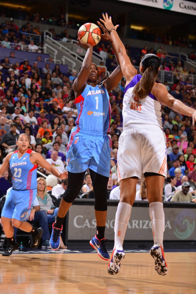 PHOENIX, AZ - JULY 14: DeLisha Milton-Jones #1 of the Atlanta Dream shoots against Mistie Bass #8 of the Phoenix Mercury on July 14, 2015 at US Airways Center in Phoenix, Arizona. NOTE TO USER: User expressly acknowledges and agrees that, by downloading and or using this Photograph, user is consenting to the terms and conditions of the Getty Images License Agreement. Mandatory Copyright Notice: Copyright 2015 NBAE (Photo by Barry Gossage/NBAE via Getty Images)
