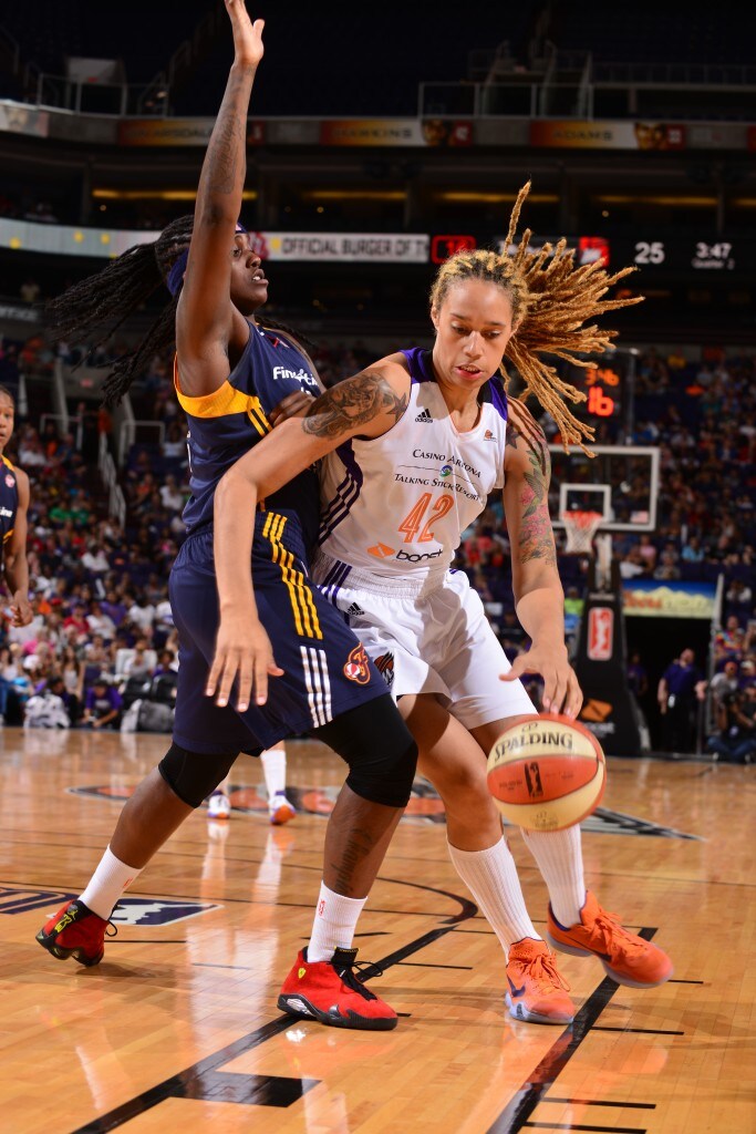 PHOENIX, AZ - AUGUST 16: Brittney Griner #42 of the Phoenix Mercury drives against Lynetta Kizer #12 of the Indiana Fever