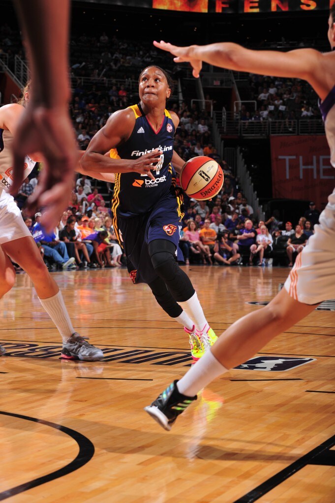 Tamika Catching #24 of the Indiana Fever drives against the Phoenix Mercury