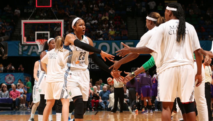 Maya Moore #23 of the Minnesota Lynx hi fives her teammates during a game against the Phoenix Mercury