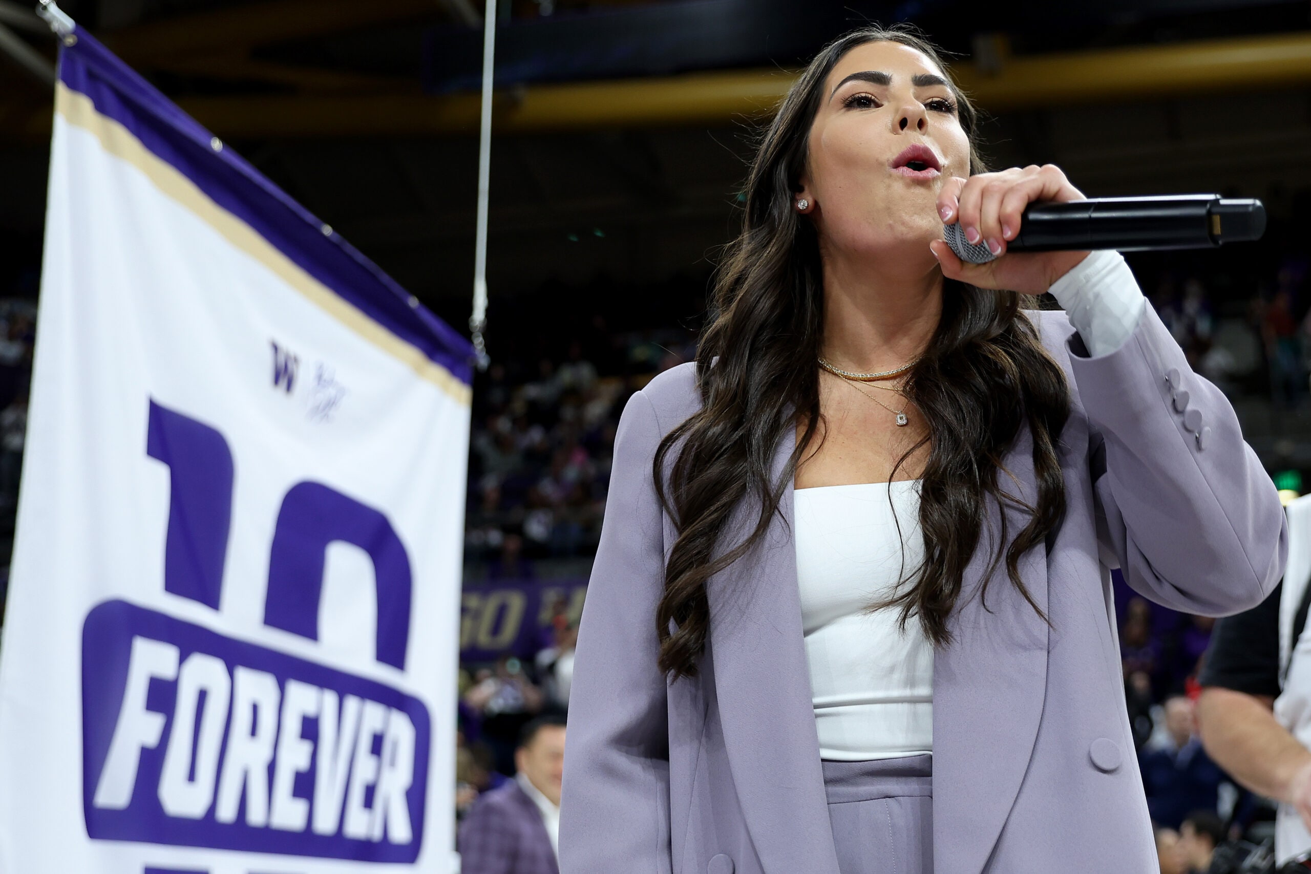Kelsey Plum pretends to bark like a husky dog during her #10 jersey retirement ceremony