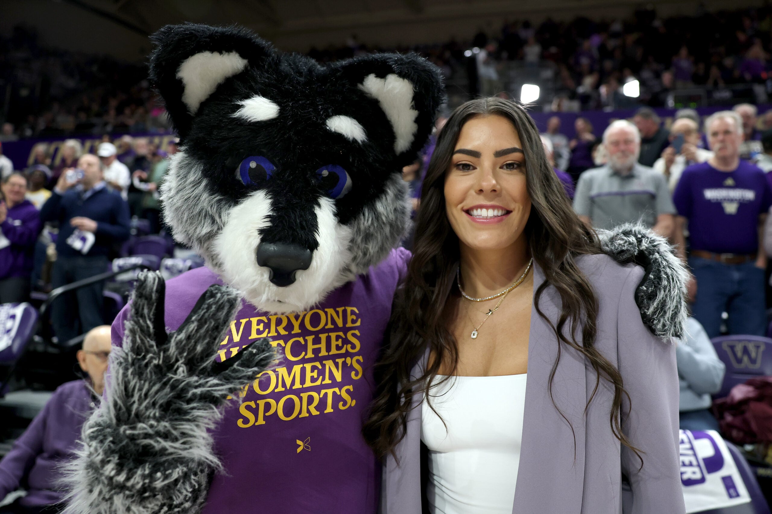 Kelsey Plum poses with mascot Harry the Husky before her #10 jersey retirement ceremony