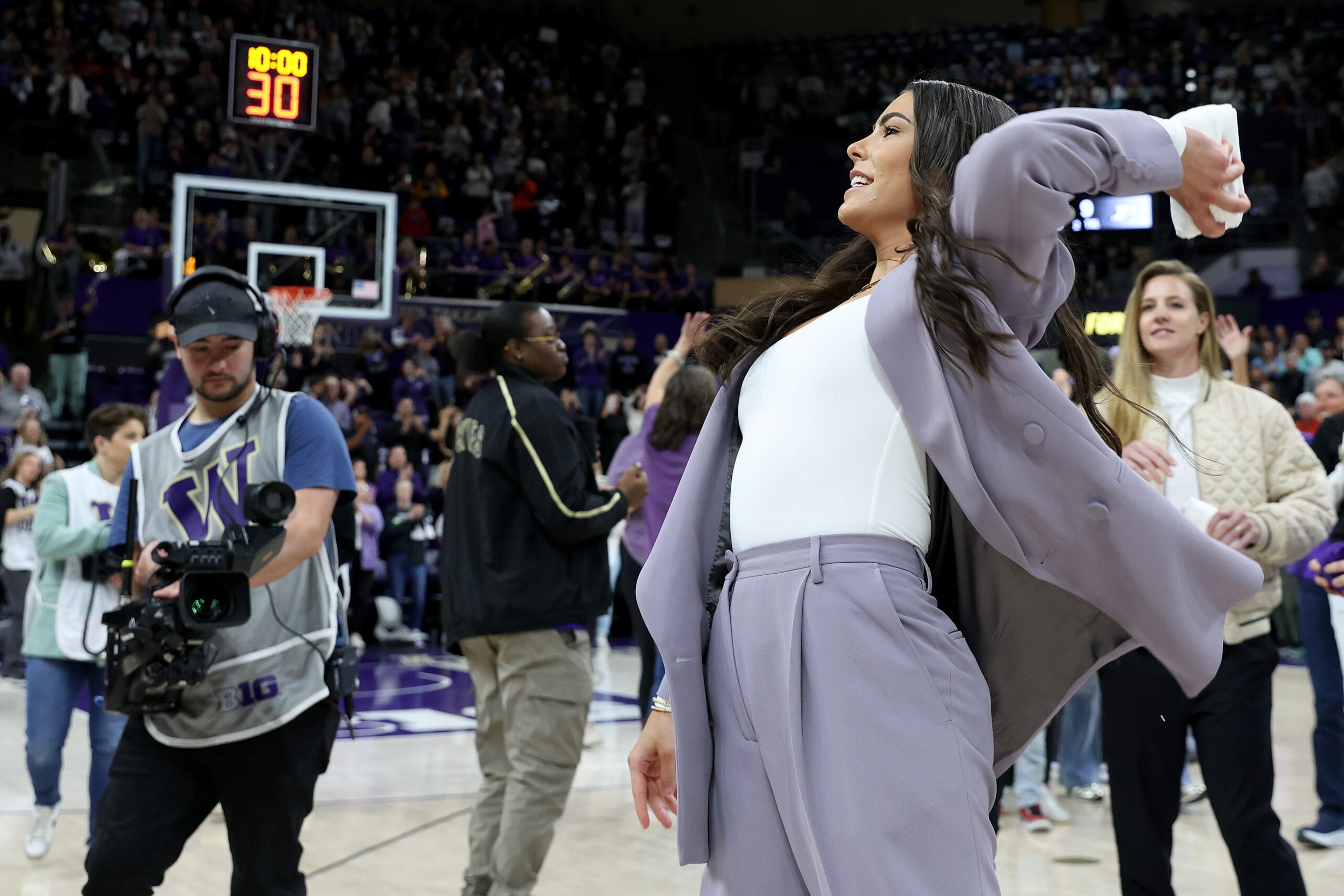 Kelsey Plum throws a t-shirt before her #10 jersey retirement ceremony