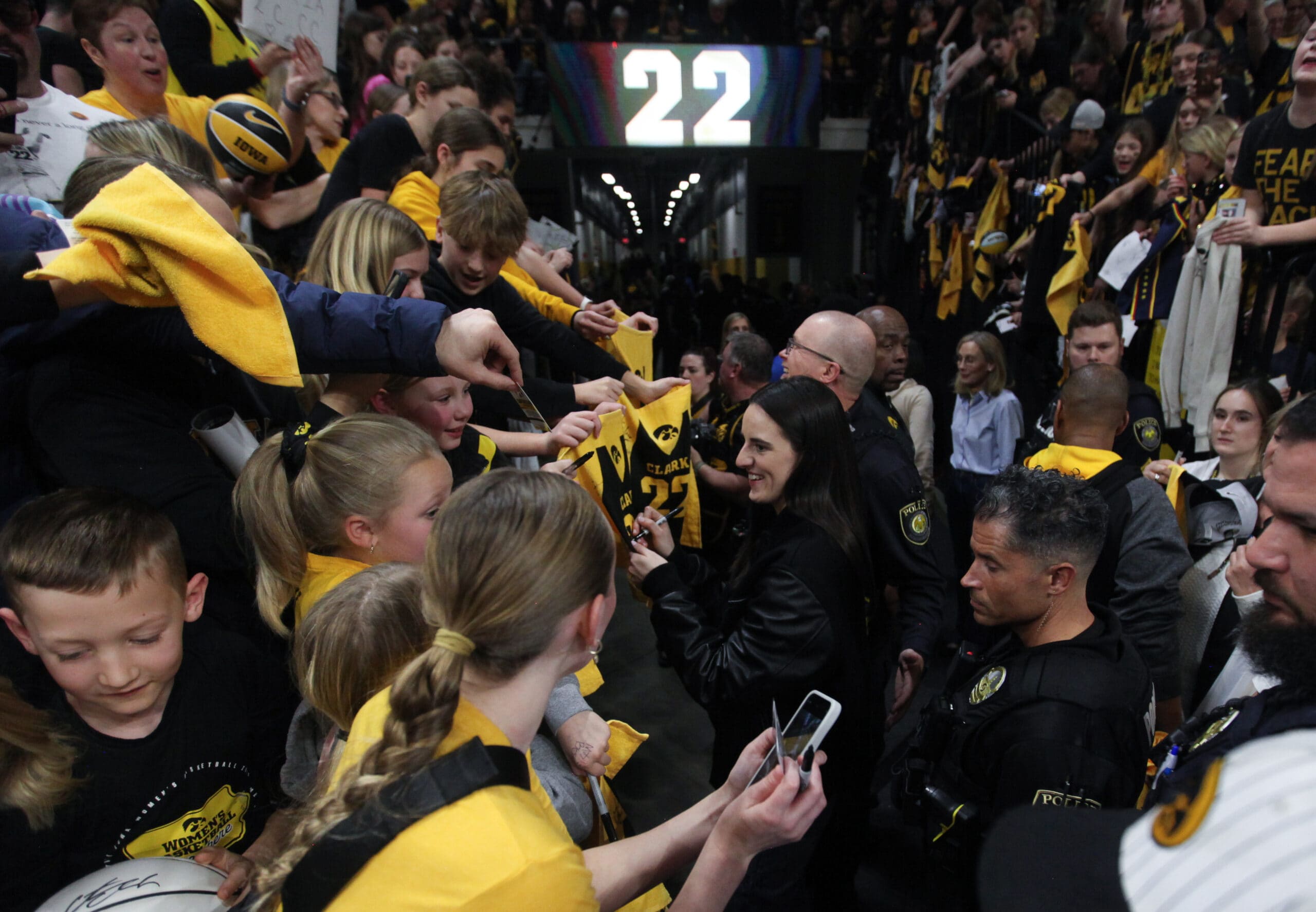 Caitlin Clark signs autographs for fans after her jersey retirement ceremony following the match-up against the USC Trojans, at Carver-Hawkeye Arena