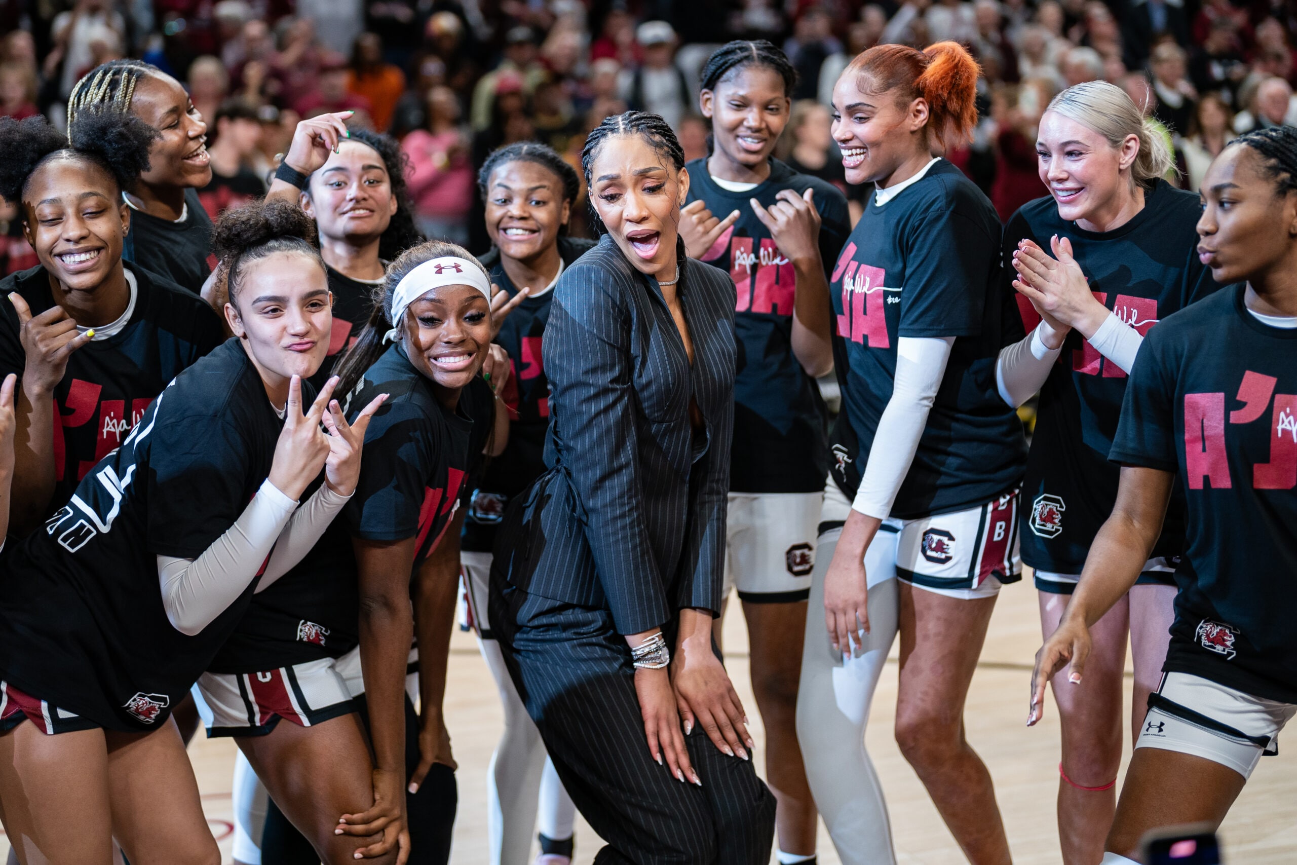 A'ja Wilson celebrates with the team after her jersey retirement ceremony