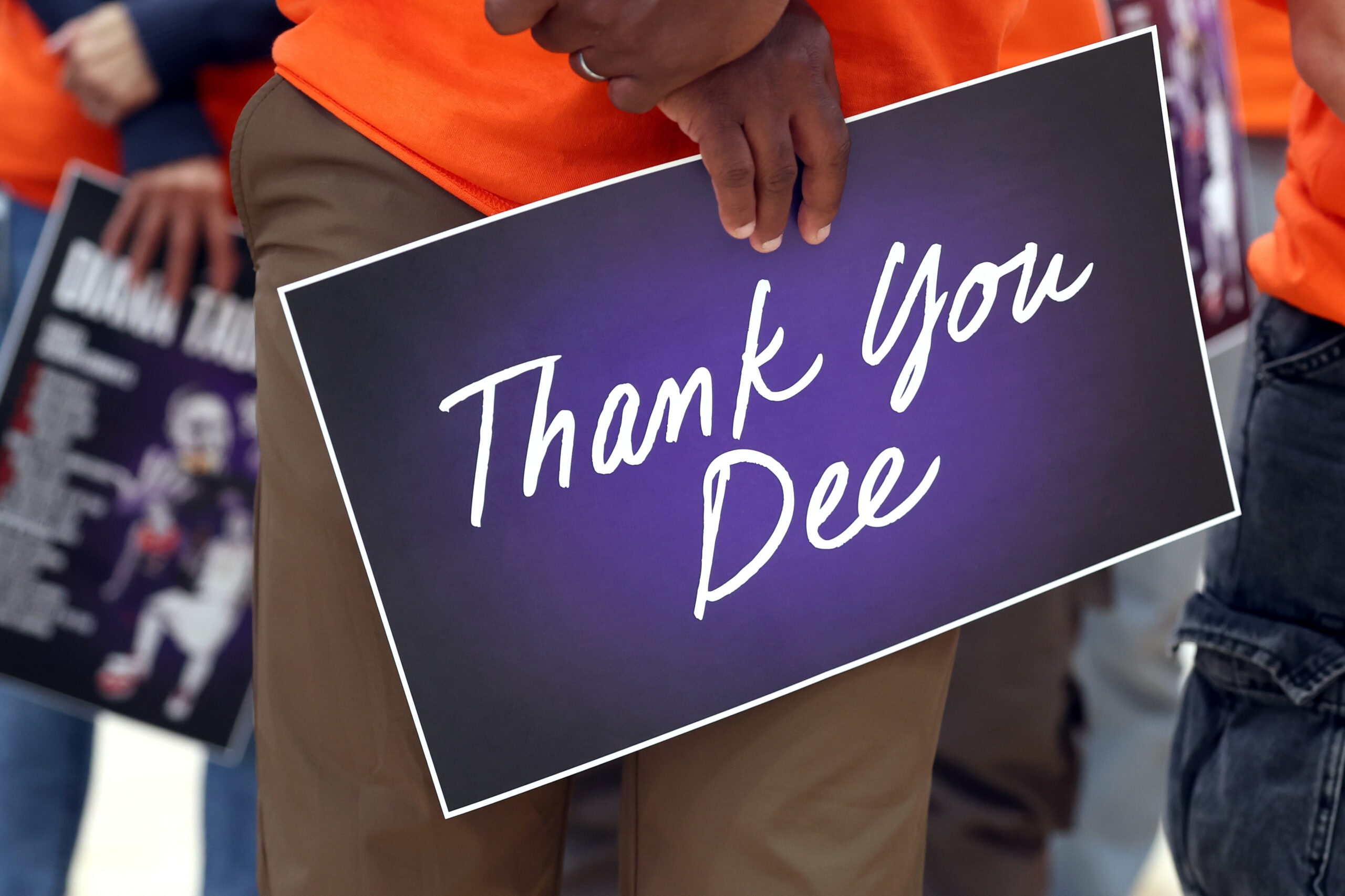 An audience member holds a sign while Diana Taurasi speaks during her retirement press conference