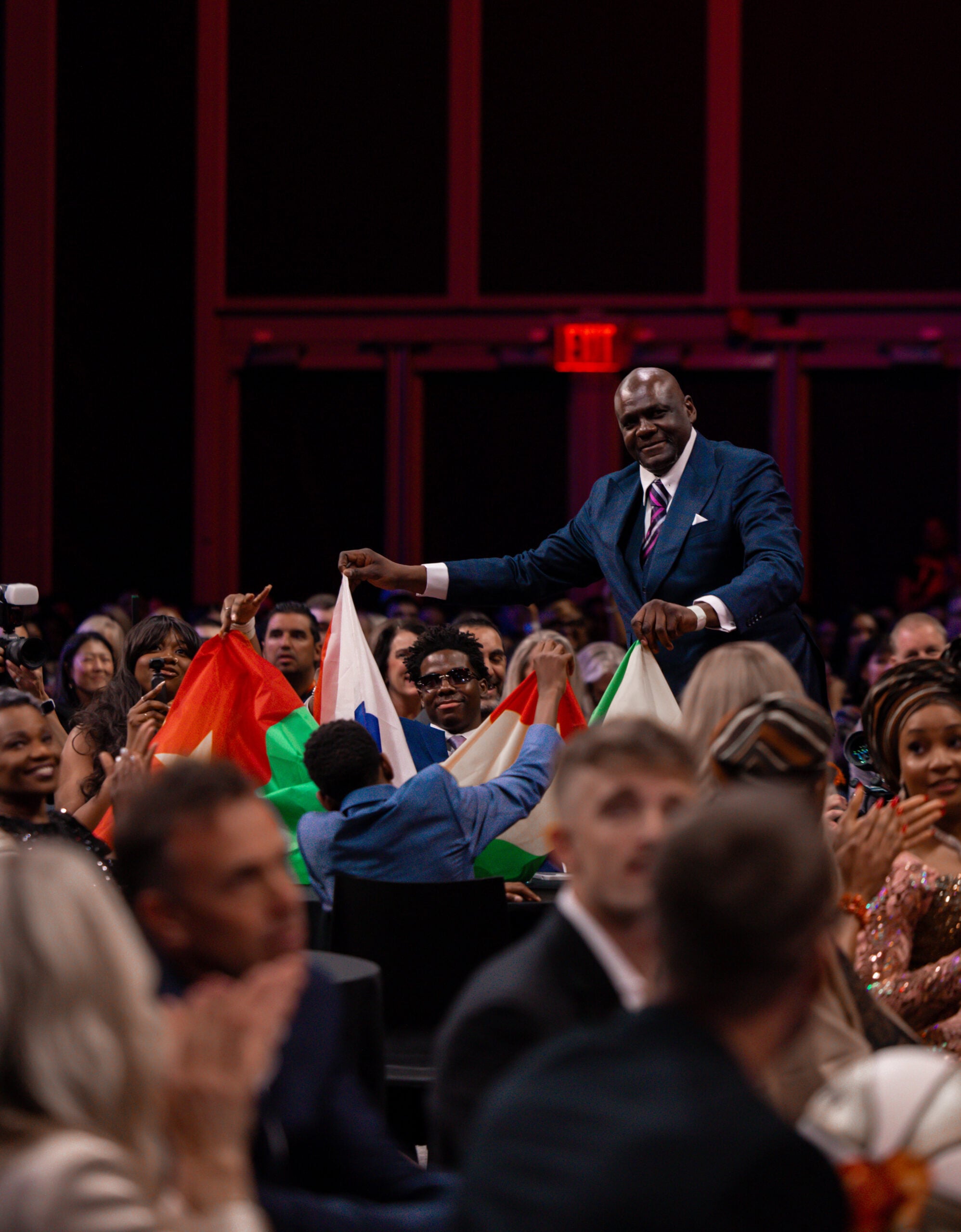 Dominique Malonga's family celebrate her with their national flag after she is drafted No. 2 at the 2025 WNBA Draft