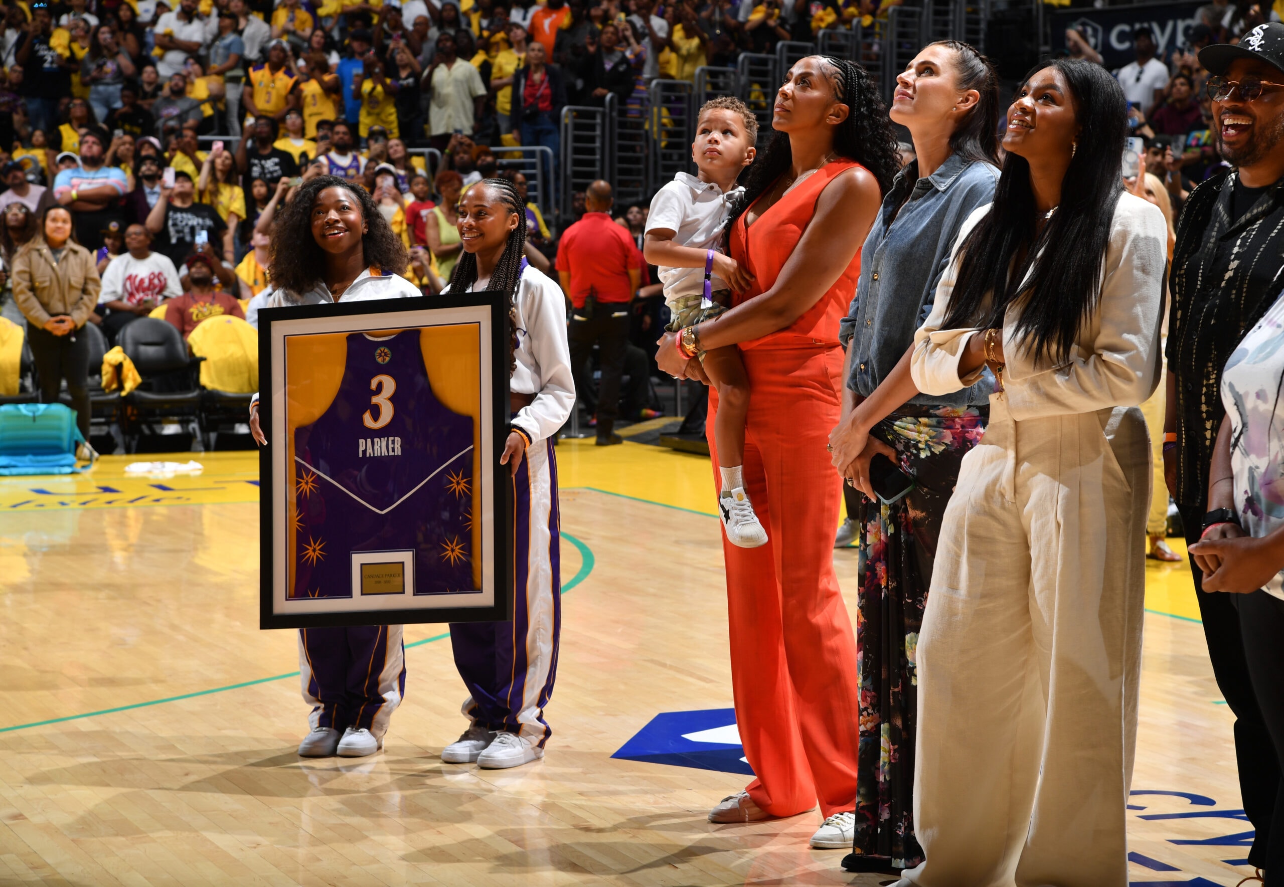 Candace Parker and her family look on as her jersey is displayed in the rafters during her Los Angeles Sparks jersey retirement