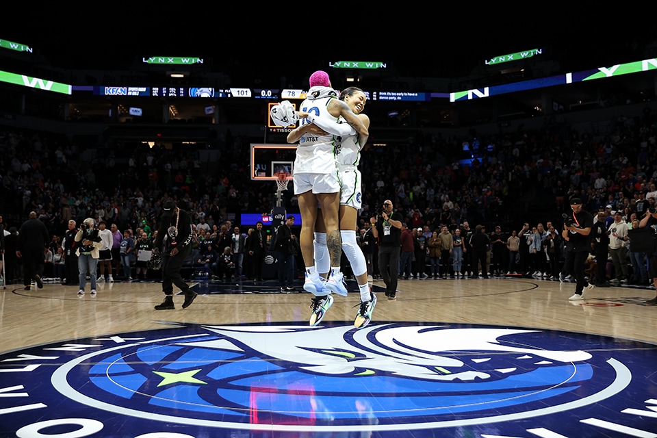 #10 Courtney Williams and #24 Napheesa Collier of the Minnesota Lynx celebrating postgame at the logo