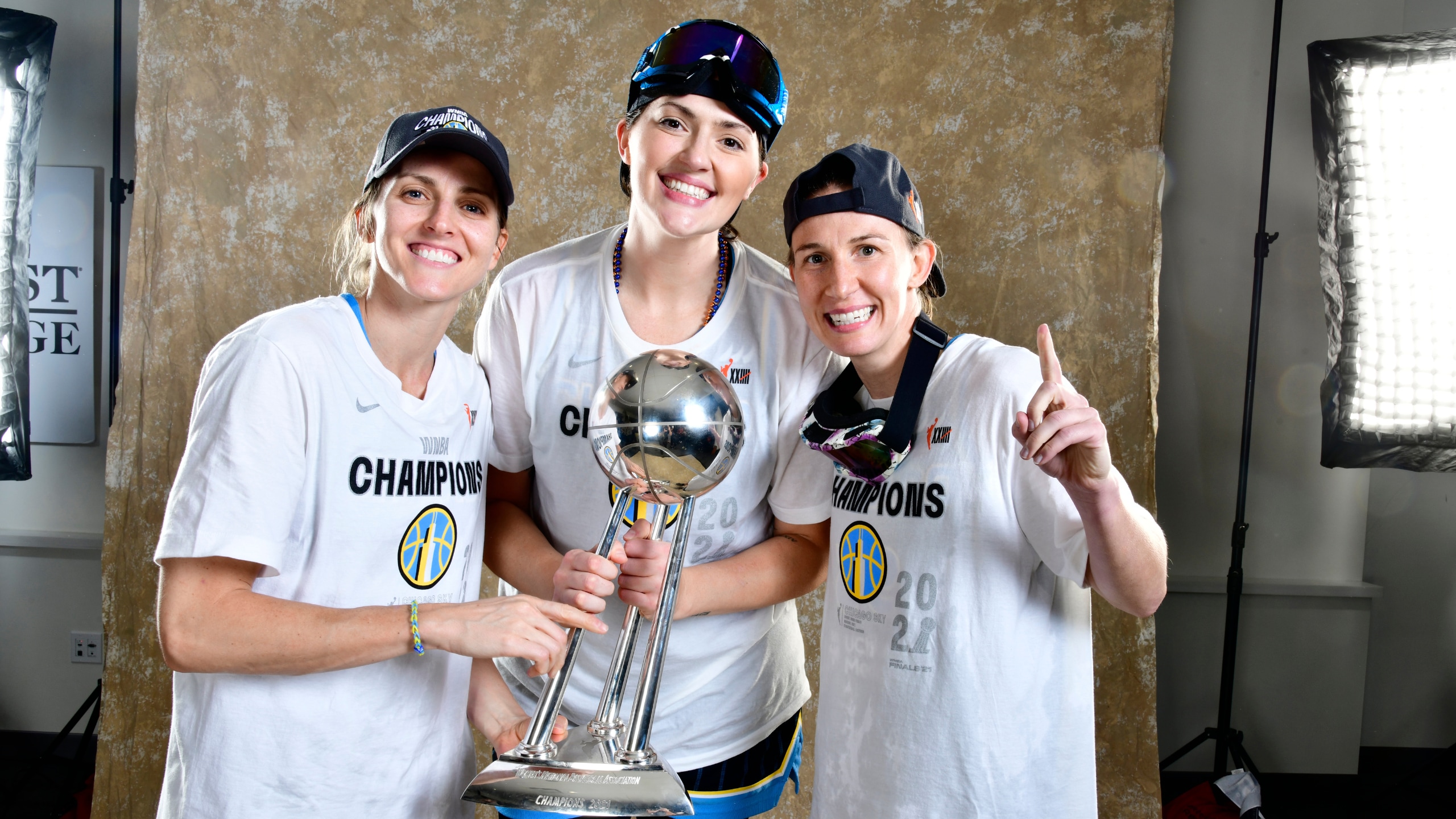 Allie Quigley #14, Stefanie Dolson #31 and Courtney Vandersloot #22 of the Chicago Sky pose for a portrait with the WNBA Championship Trophy after winning Game Four of the 2021 WNBA Finals