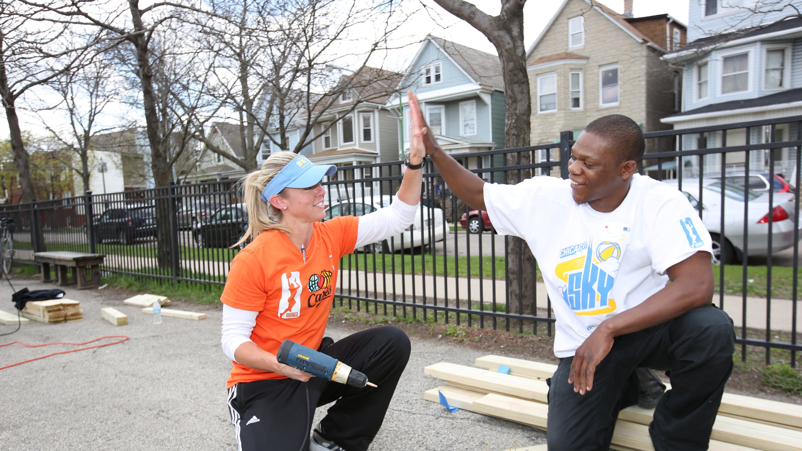 Allie Quigley #14 of the Chicago Sky and coaches team up with City Year Chicago to enhance various parts of James Monroe Elementary School on May 3, 2014
