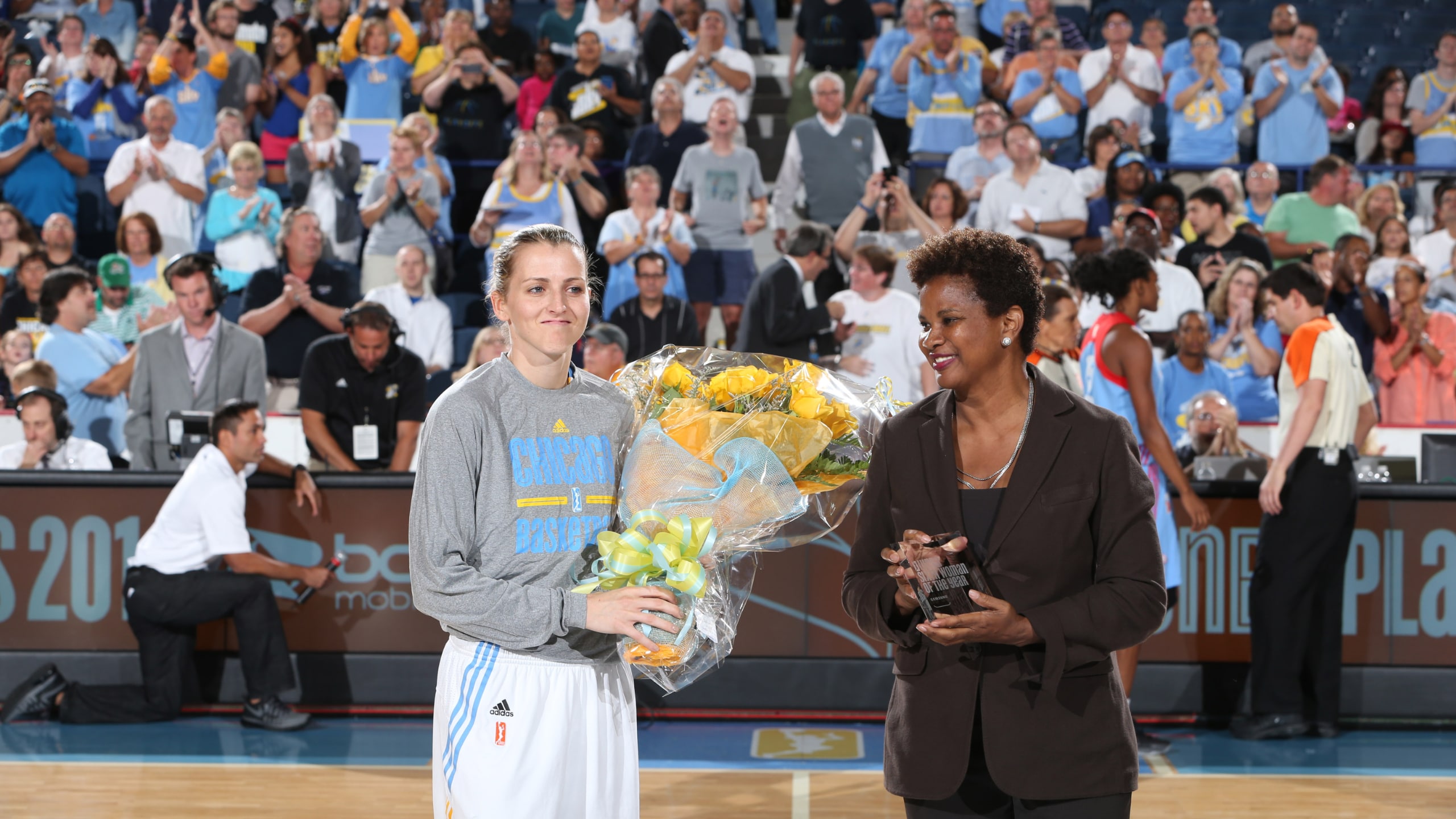 WNBA Chief of Basketball Operations and Player Relations Director of Operations Renee Brown presents Allie Quigley #14 of the Chicago Sky with the 2014 WNBA Sixth Woman of the Year award prior to Game Two of the Eastern Conference Semifinals