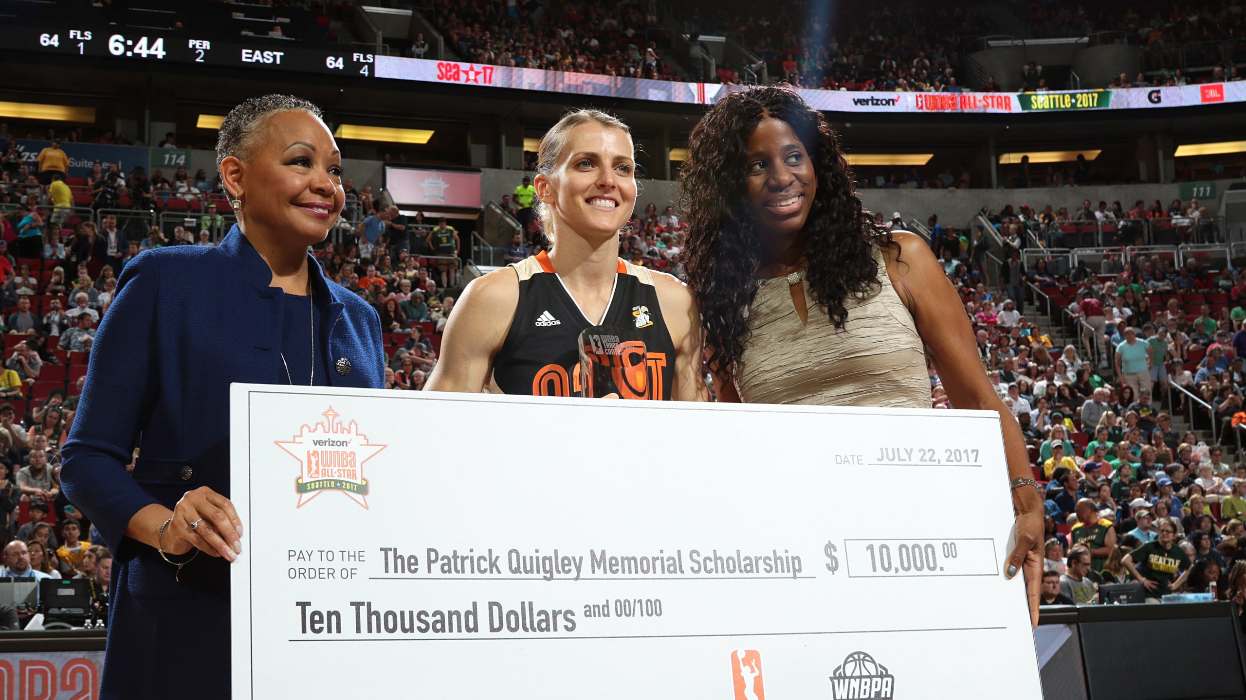 WNBA President Lisa Borders presents a check to Allie Quigley #14 of the Eastern Conference All-Stars, center, after winning the halftime Three Point Contest during the Verizon WNBA All-Star Game 2017