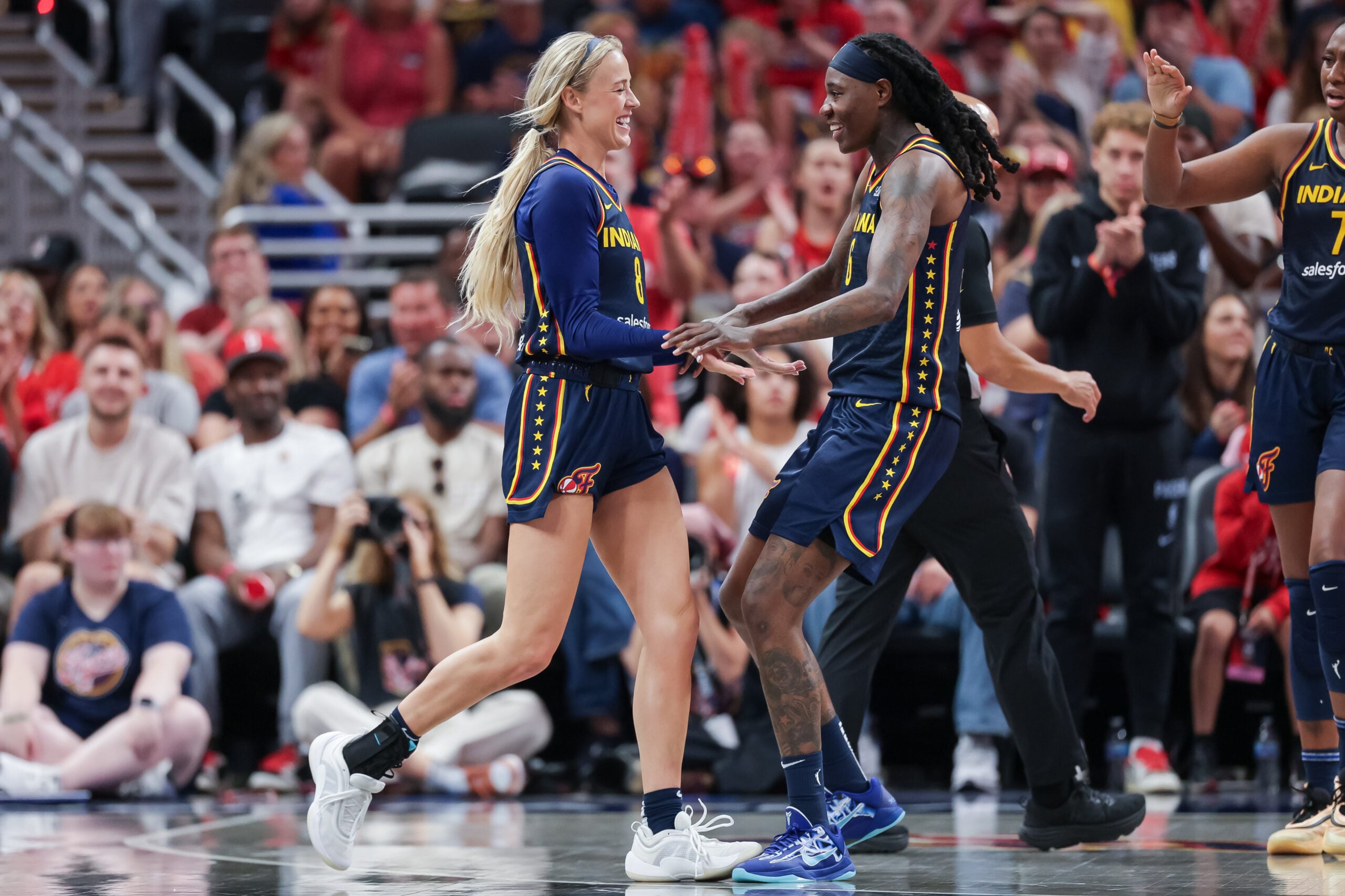 Sophie Cunningham #8 and Natasha Howard #6 of the Indiana Fever react during the game against the Los Angeles Sparks at Gainbridge Fieldhouse on July 5, 2025 in Indianapolis, Indiana.