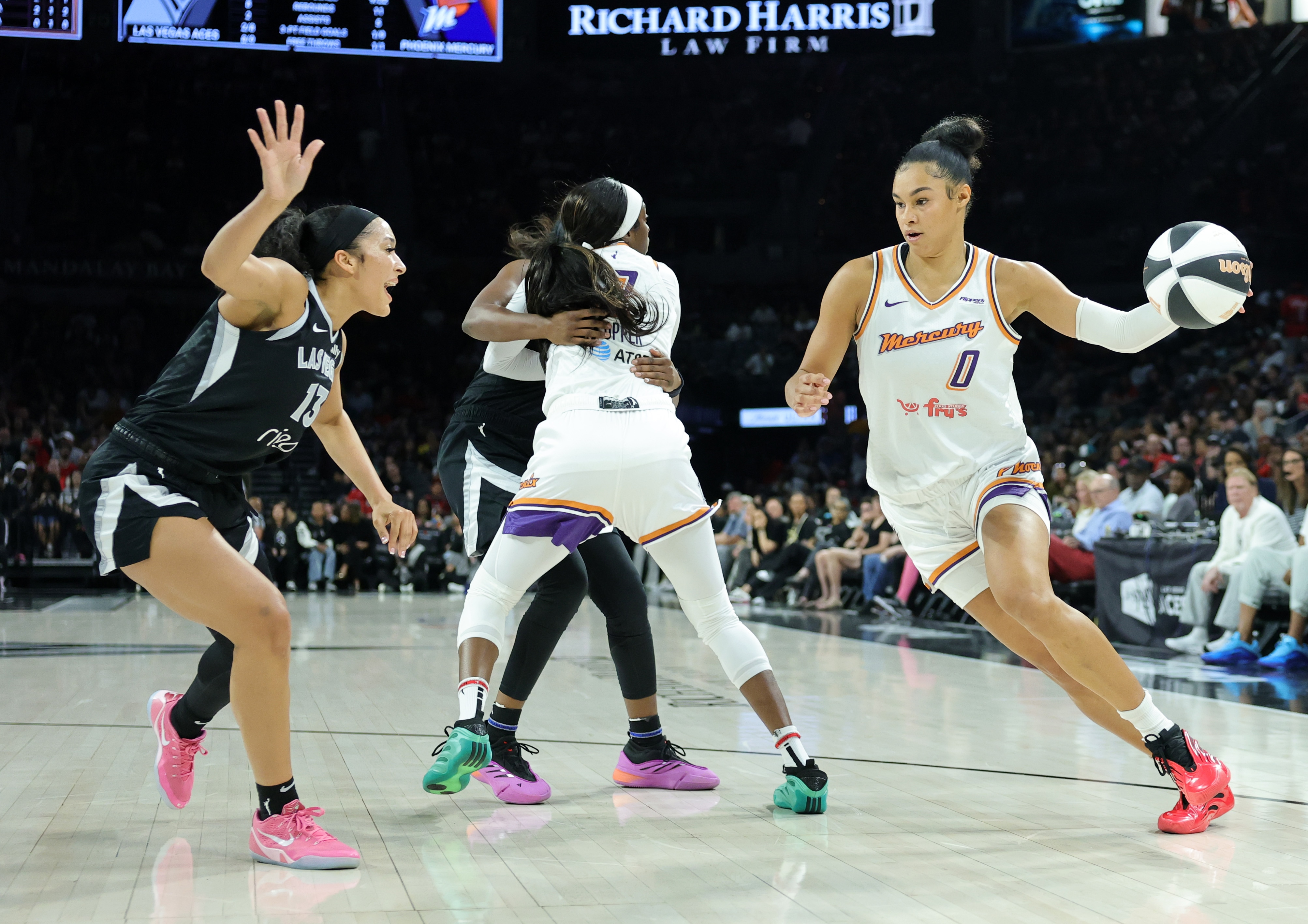 Satou Sabally #0 of the Phoenix Mercury goes around a screen by Kahleah Copper #2