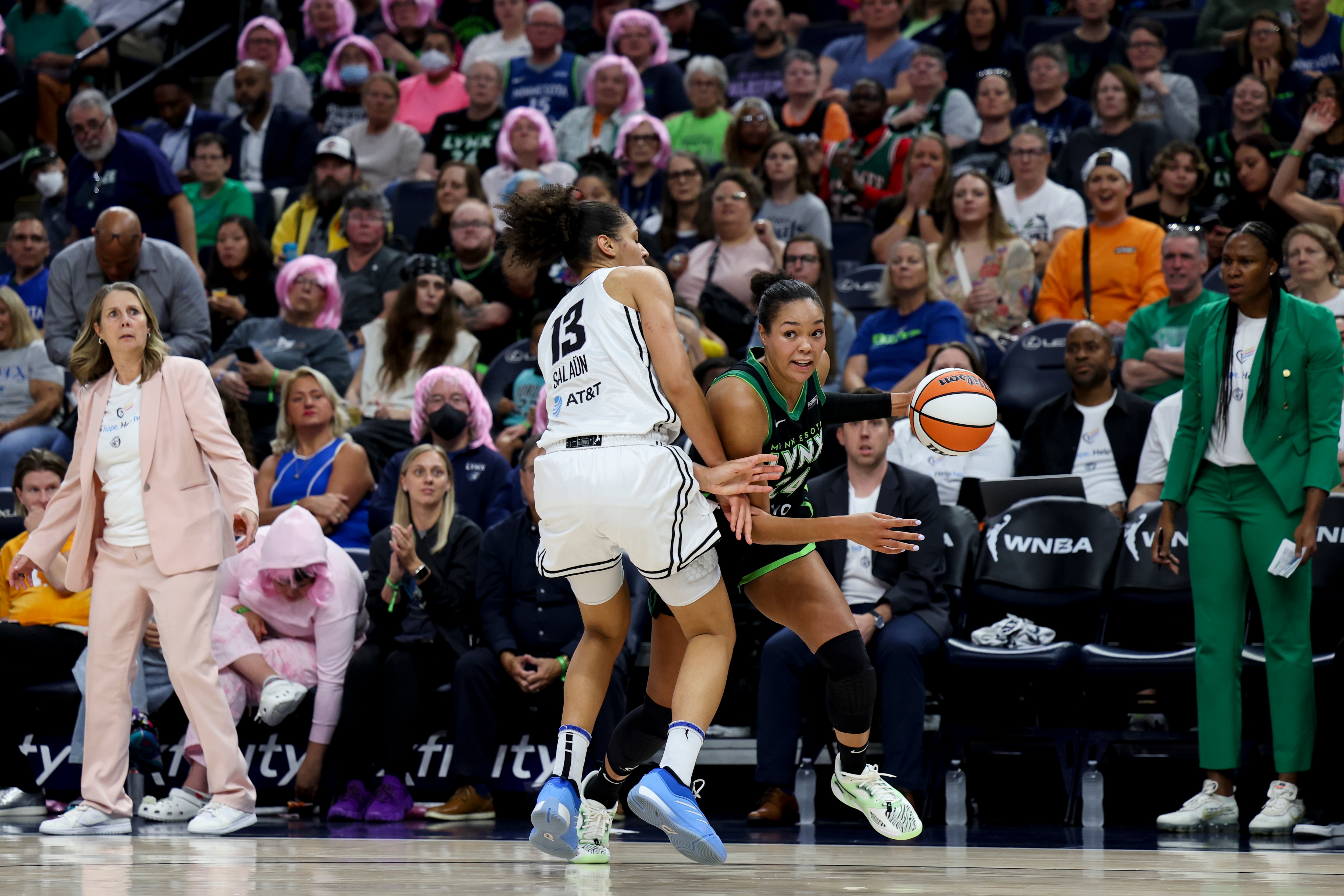 Napheesa Collier #24 of the Minnesota Lynx drives toward the hoop against Janelle Salaun #13 of the Golden State Valkyries