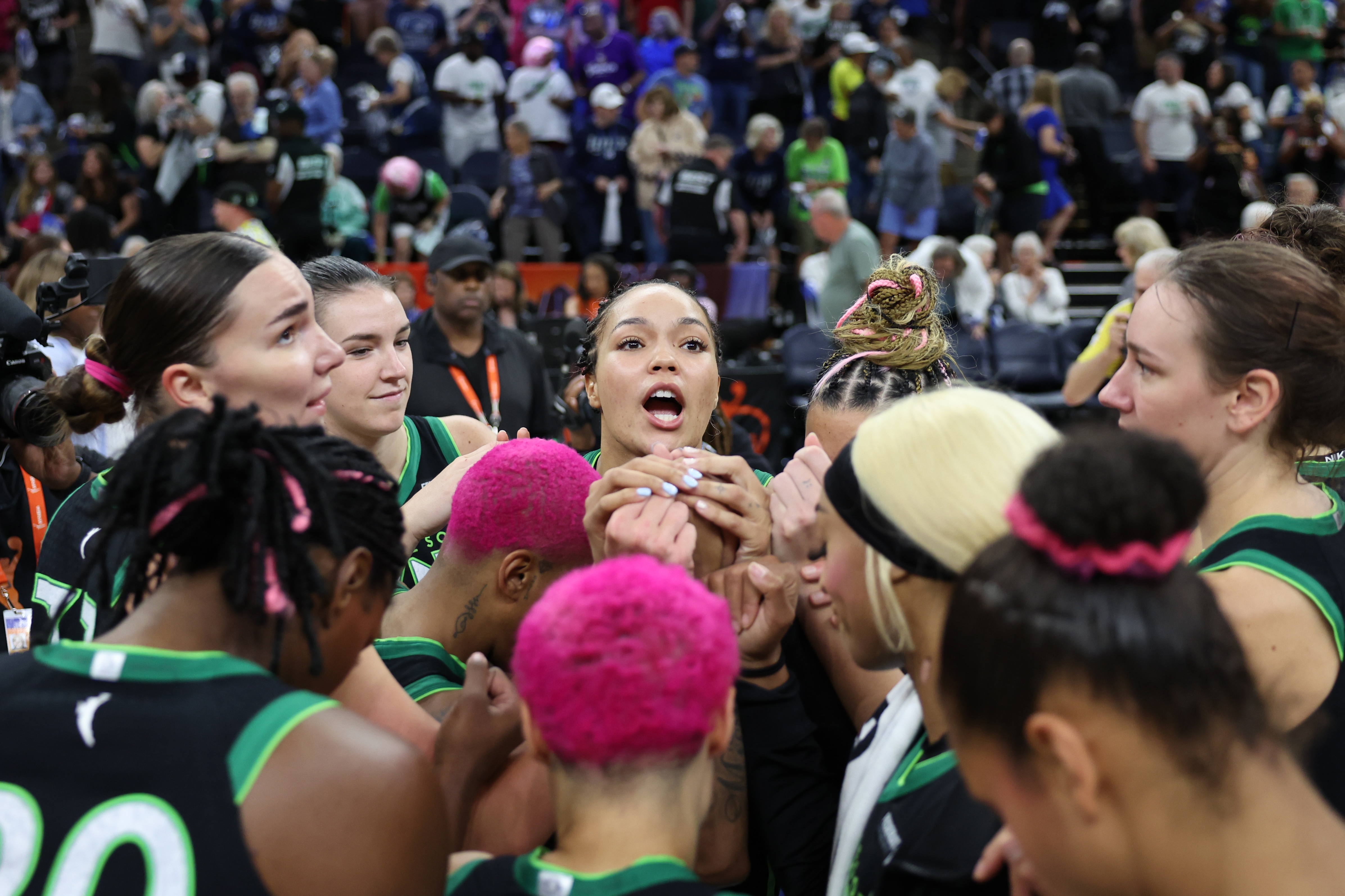 Napheesa Collier #24 of the Minnesota Lynx huddles with her teammates after winning the game against the Golden State Valkyries
