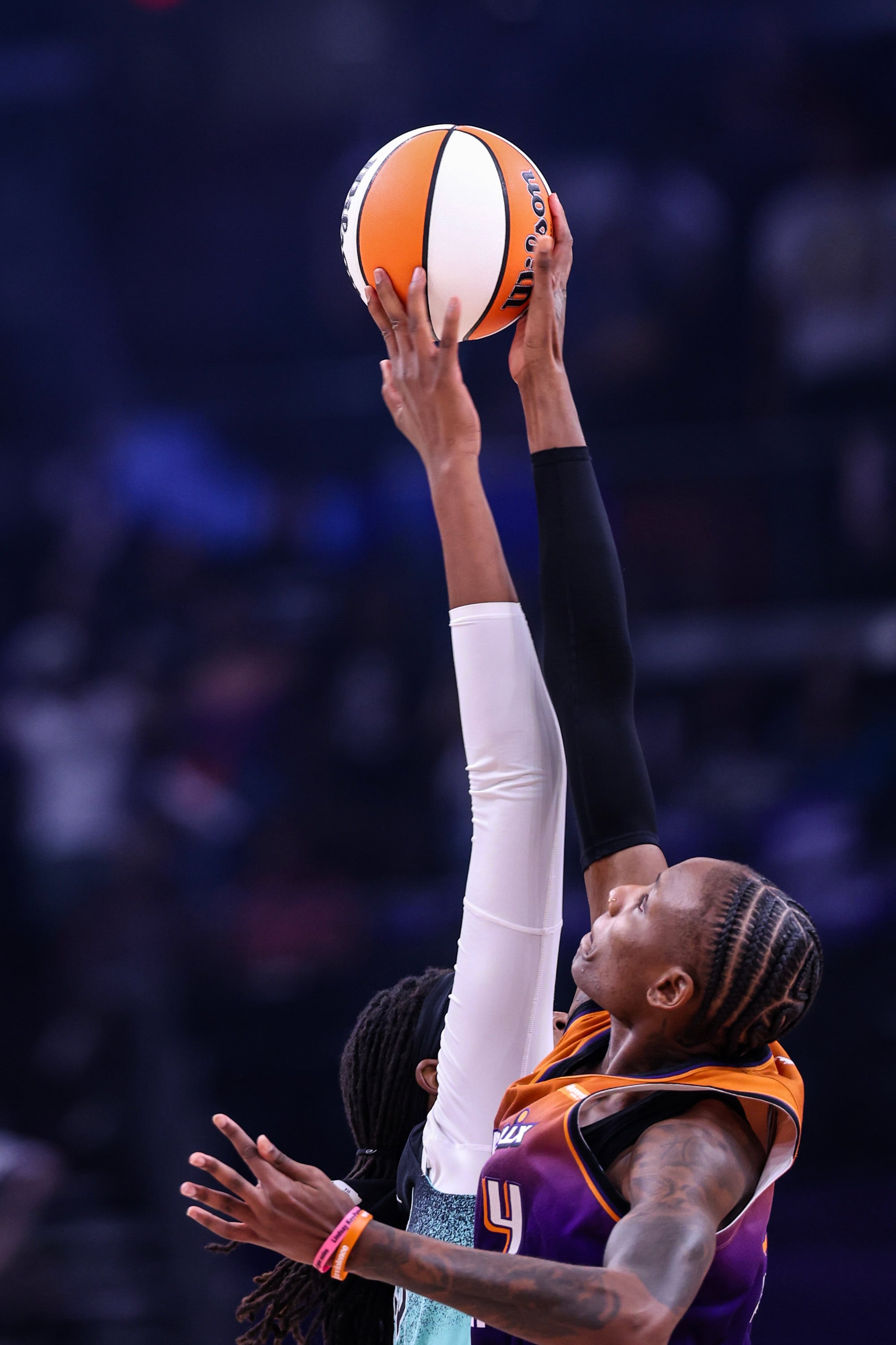 Natasha Mack #4 of the Phoenix Mercury and Jonquel Jones #35 of the New York Liberty jump for the ball