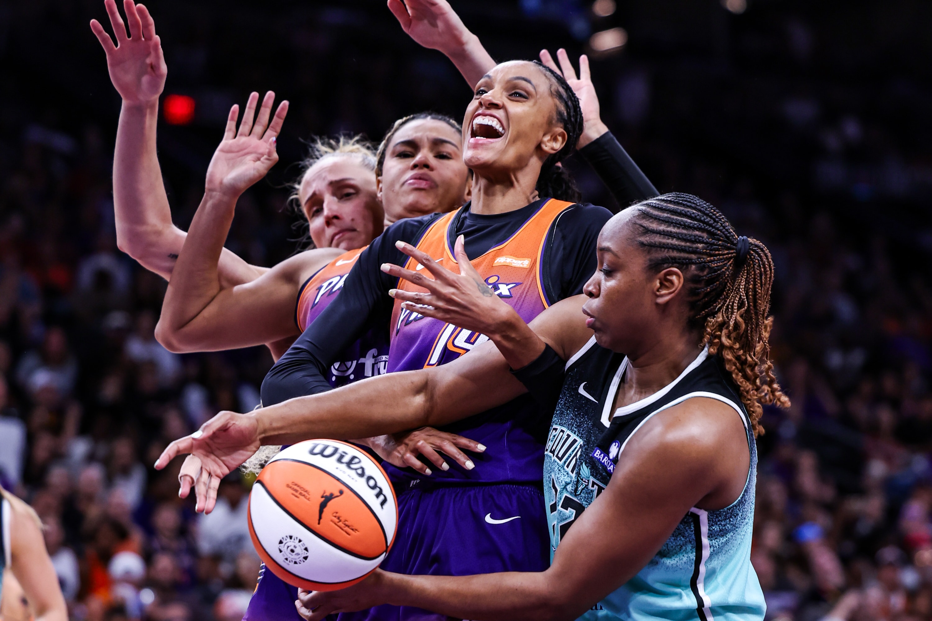 DeWanna Bonner #14 of the Phoenix Mercury and Kennedy Burke #22 of the New York Liberty both attempt to rebound the ball
