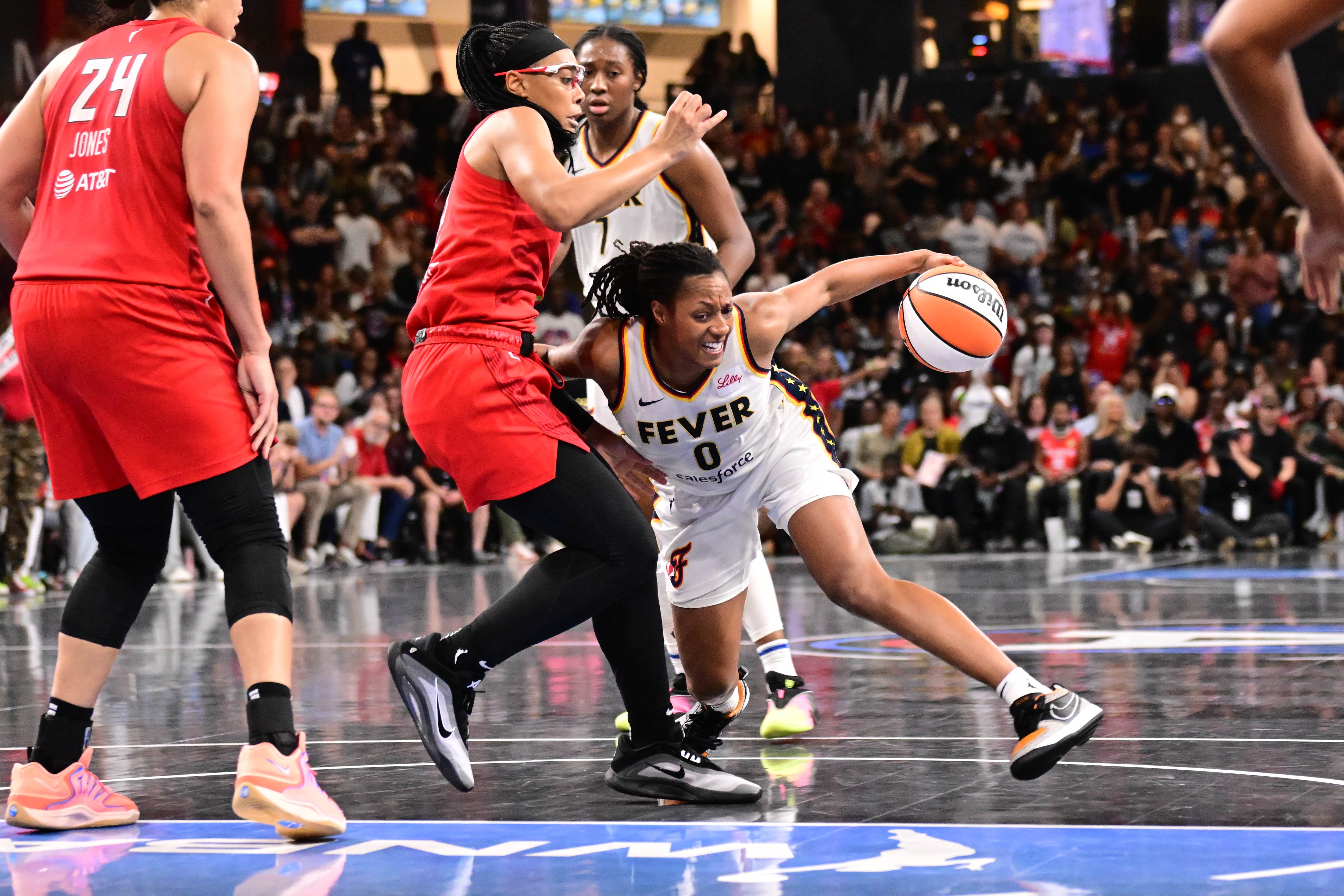 Kelsey Mitchell #0 of the Indiana Fever handles the ball