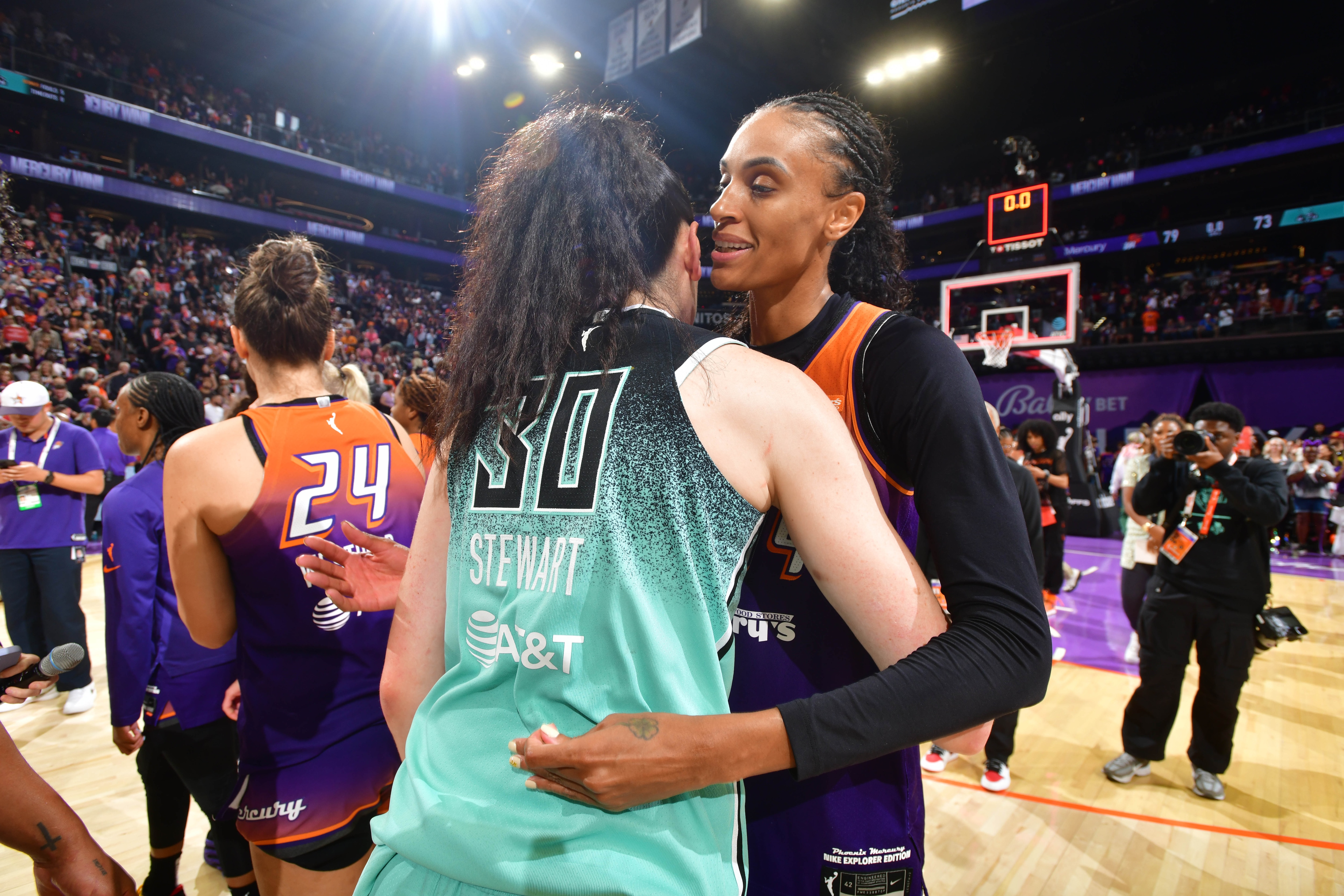 DeWanna Bonner #14 of the Phoenix Mercury & Breanna Stewart #30 of the New York Liberty hug after the game