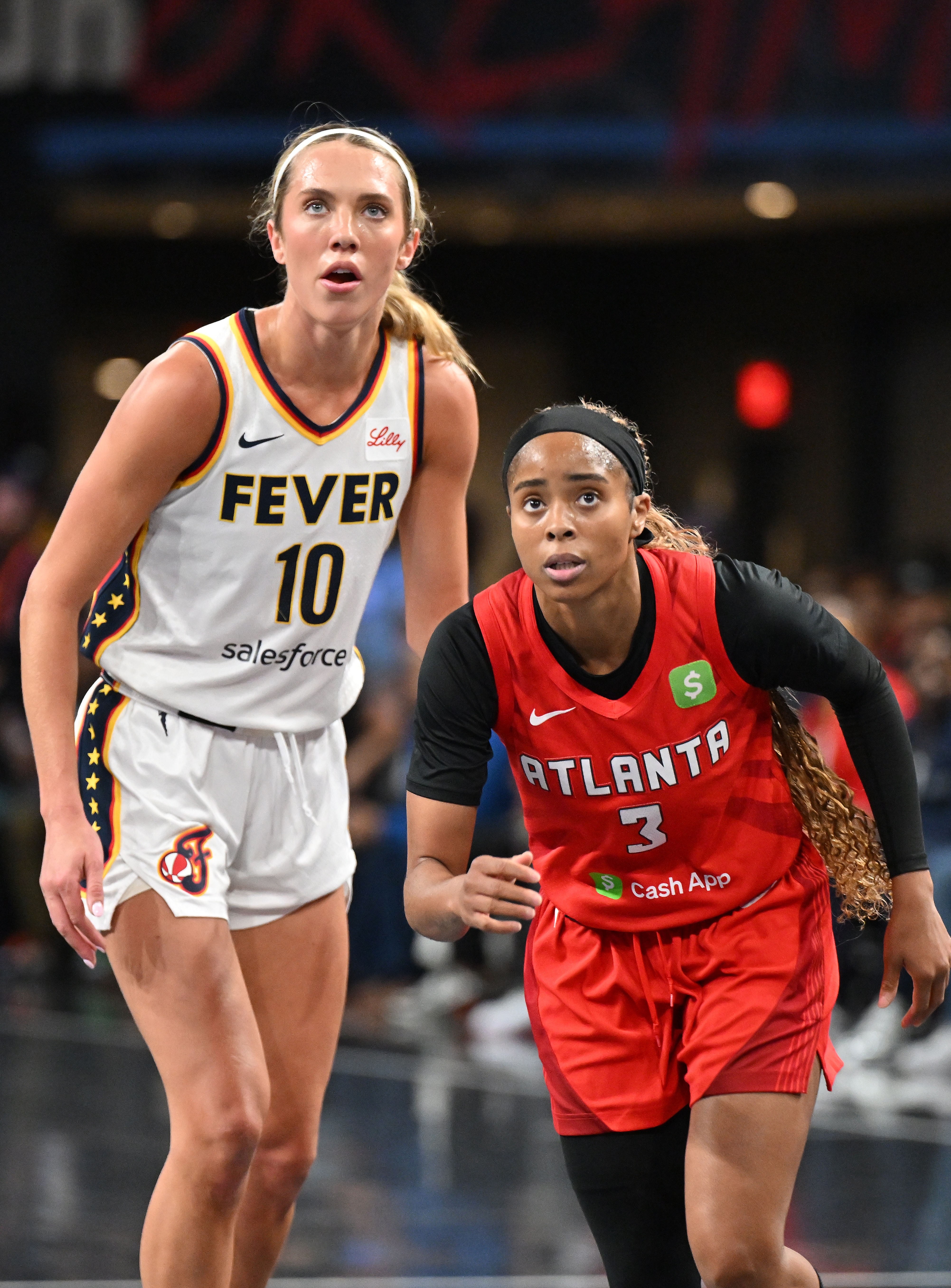 Lexie Hull #10 of the Indiana Fever and Jordin Canada #3 of the Atlanta Dream look on during first quarter