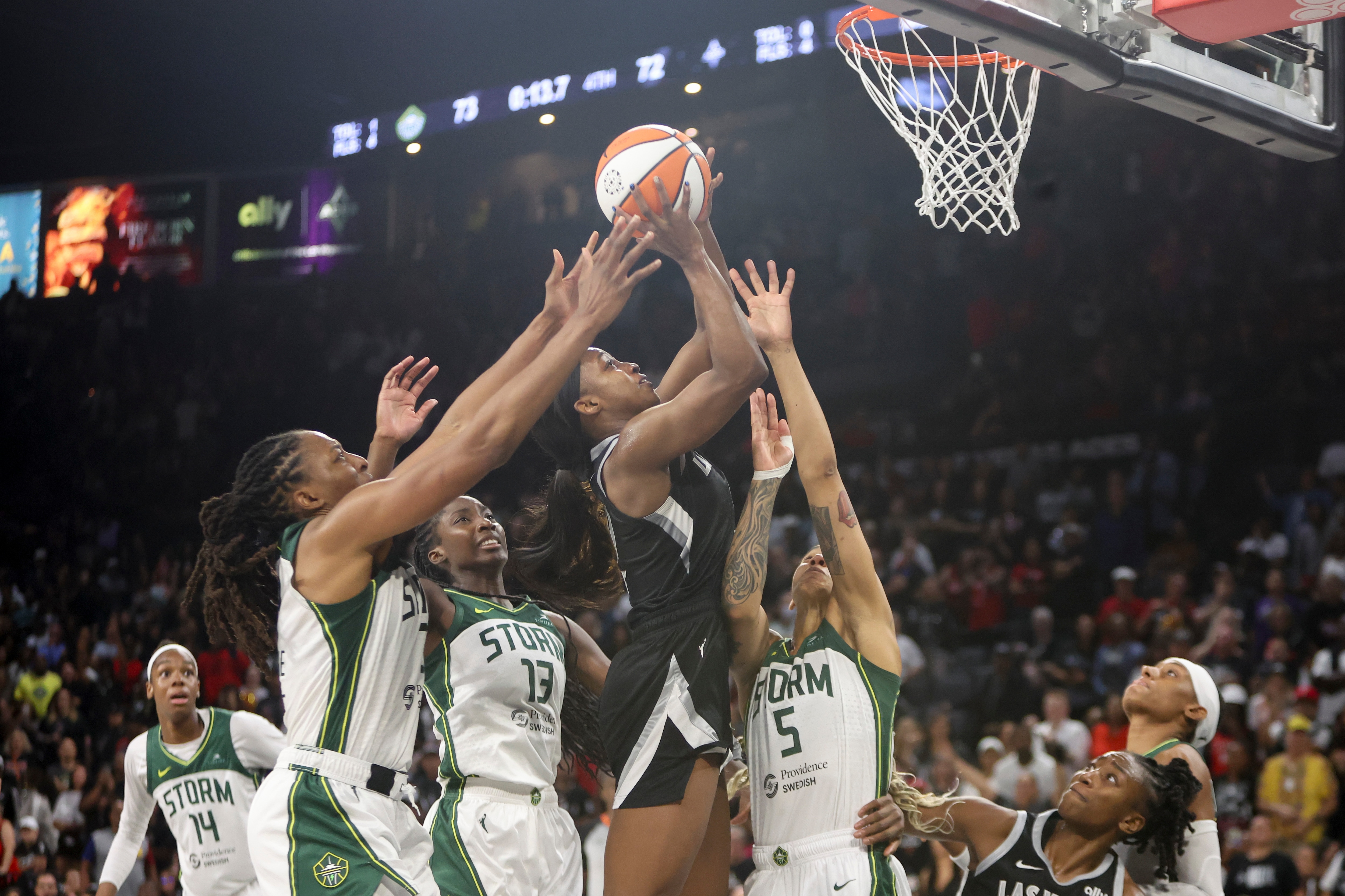 Jackie Young #0 of the Las Vegas Aces shoots the go-ahead basket against Nneka Ogwumike #3, Ezi Magbegor #13 and Gabby Williams #5 of the Seattle Storm