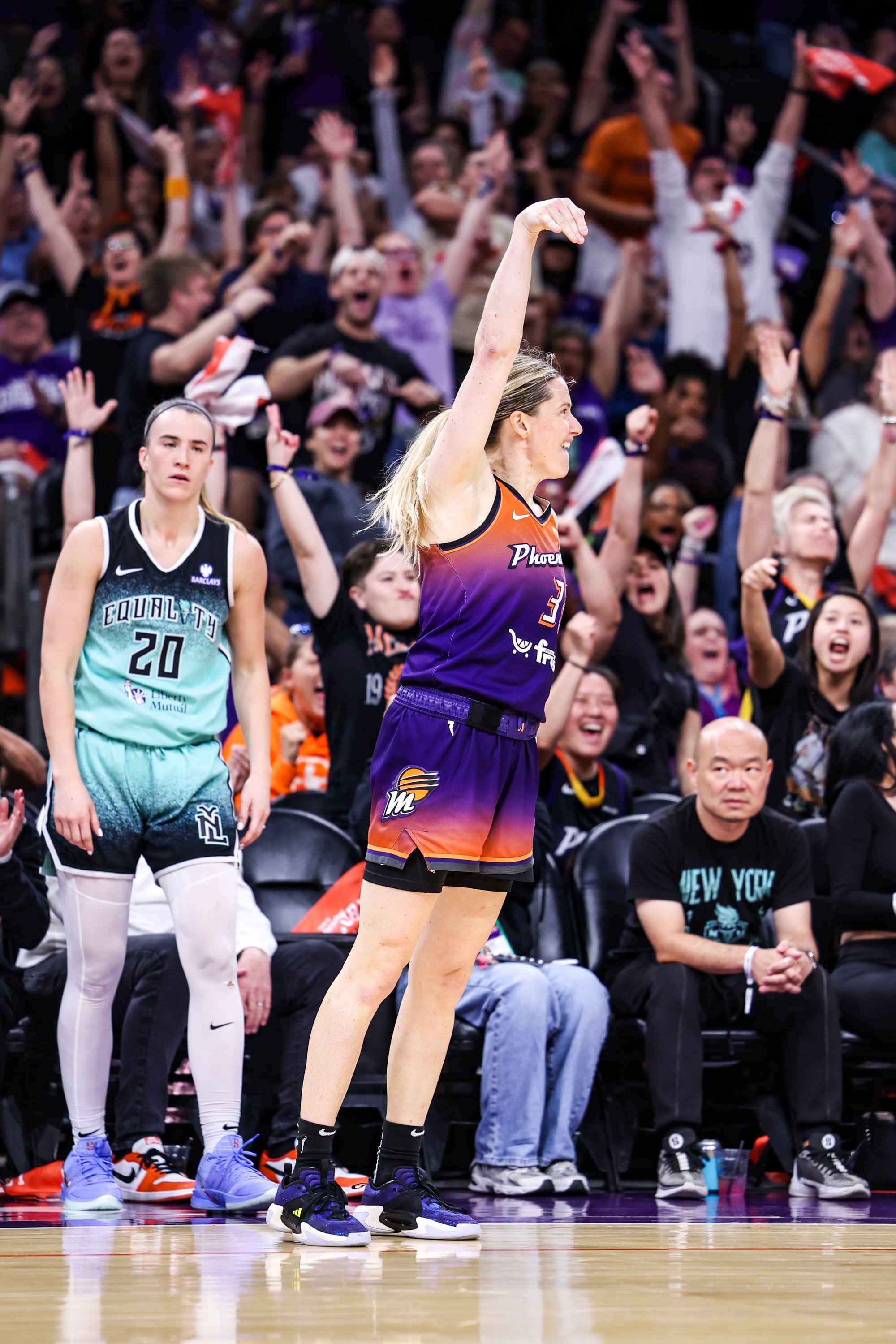 Sami Whitcomb #33 of the Phoenix Mercury celebrates a three pointer she made during the fourth quarter while Sabrina Ionescu #20 of the New York Liberty watches