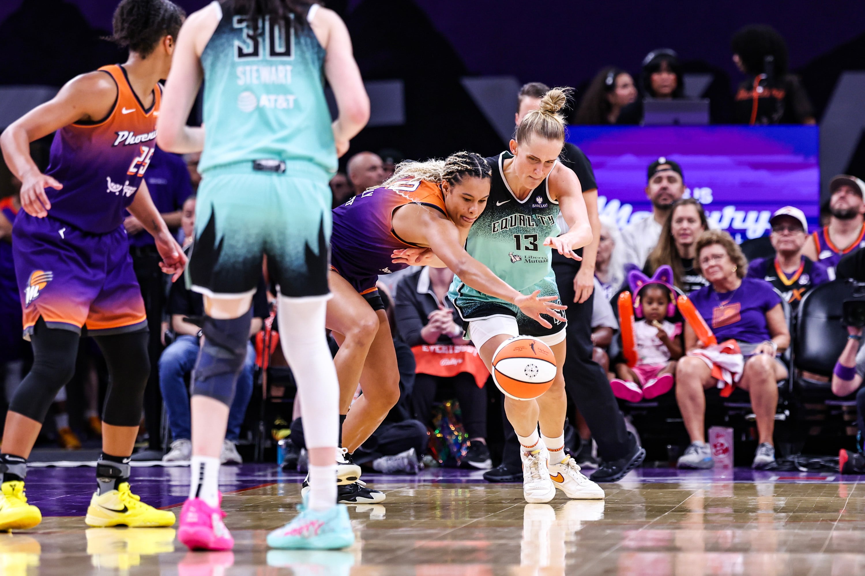 Satou Sabally #0 of the Phoenix Mercury steals the ball from Leonie Fiebich #13 of the New York Liberty