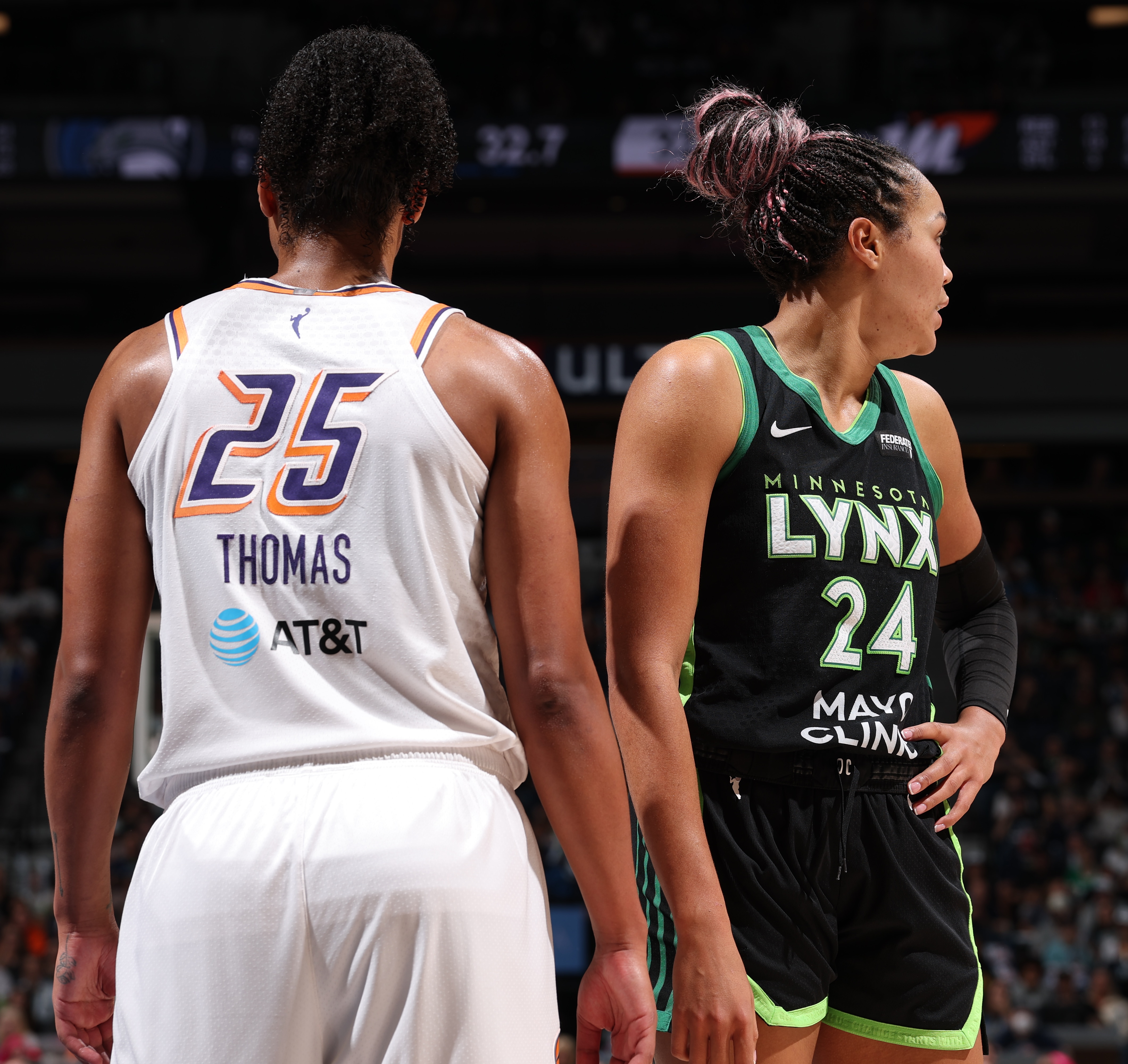Alyssa Thomas #25 of the Phoenix Mercury and Napheesa Collier #24 of the Minnesota Lynx look on during the game