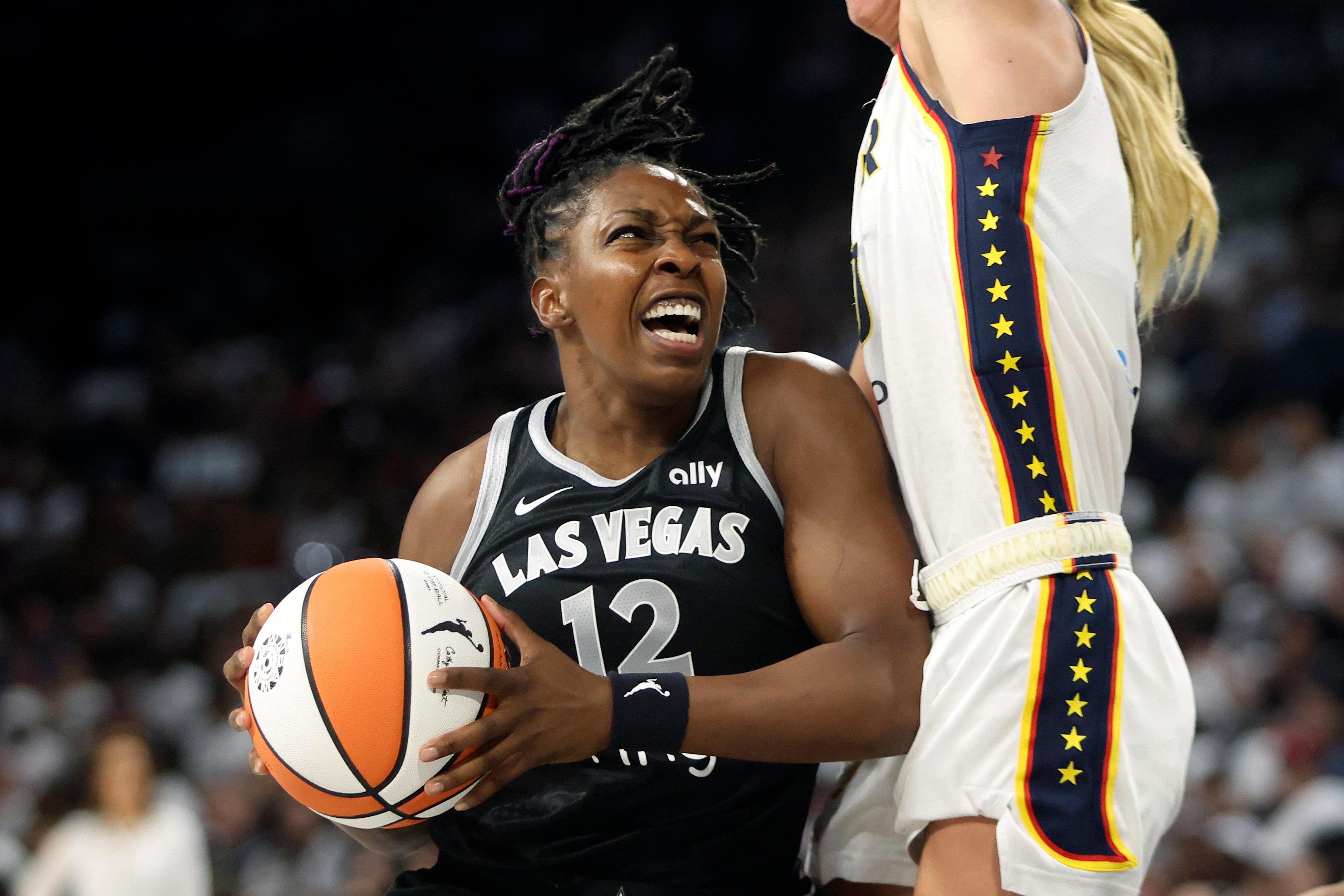 Chelsea Gray #12 of the Las Vegas Aces drives against Lexie Hull #10 of the Indiana Fever