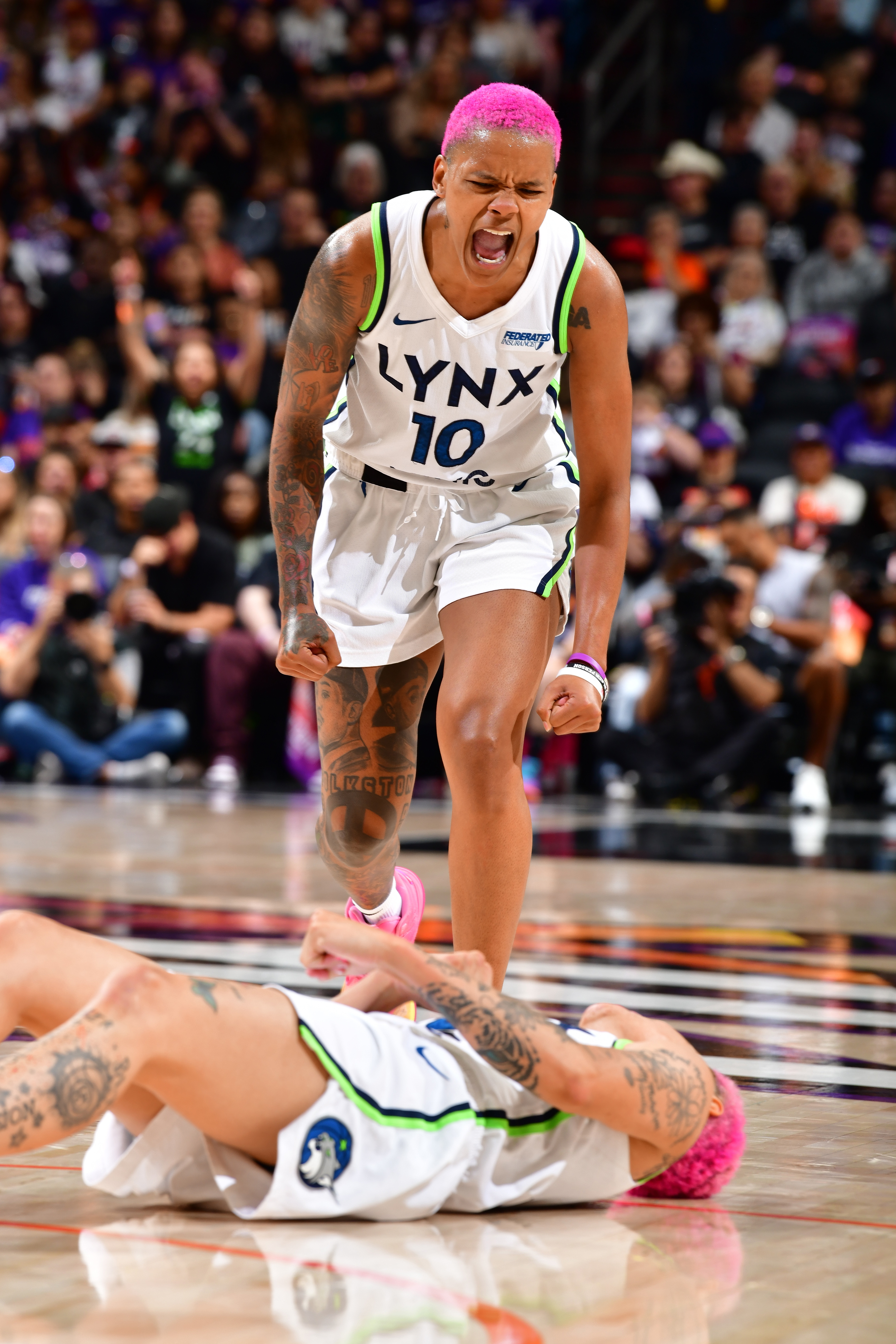 Courtney Williams #10 and Natisha Hiedeman #2 of the Minnesota Lynx celebrate during the game against the Phoenix Mercury