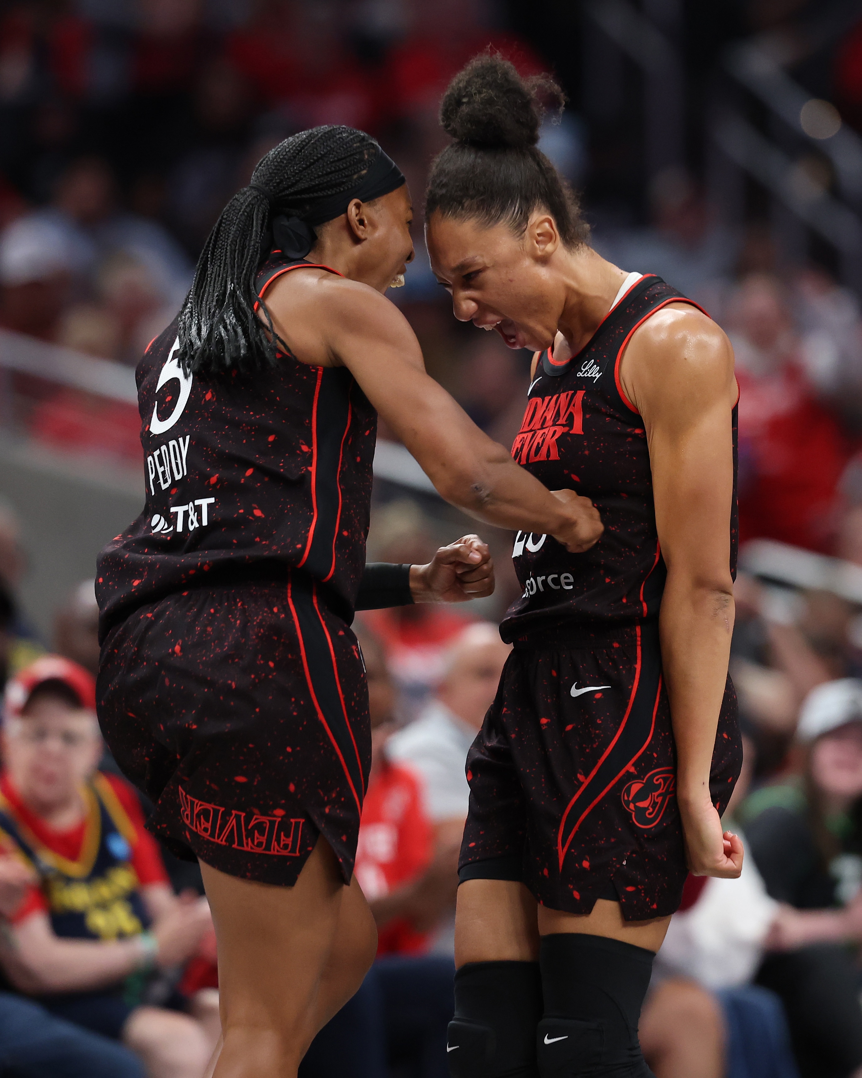 Aerial Powers #23 of the Indiana Fever and Shey Peddy #5 celebrate during the game