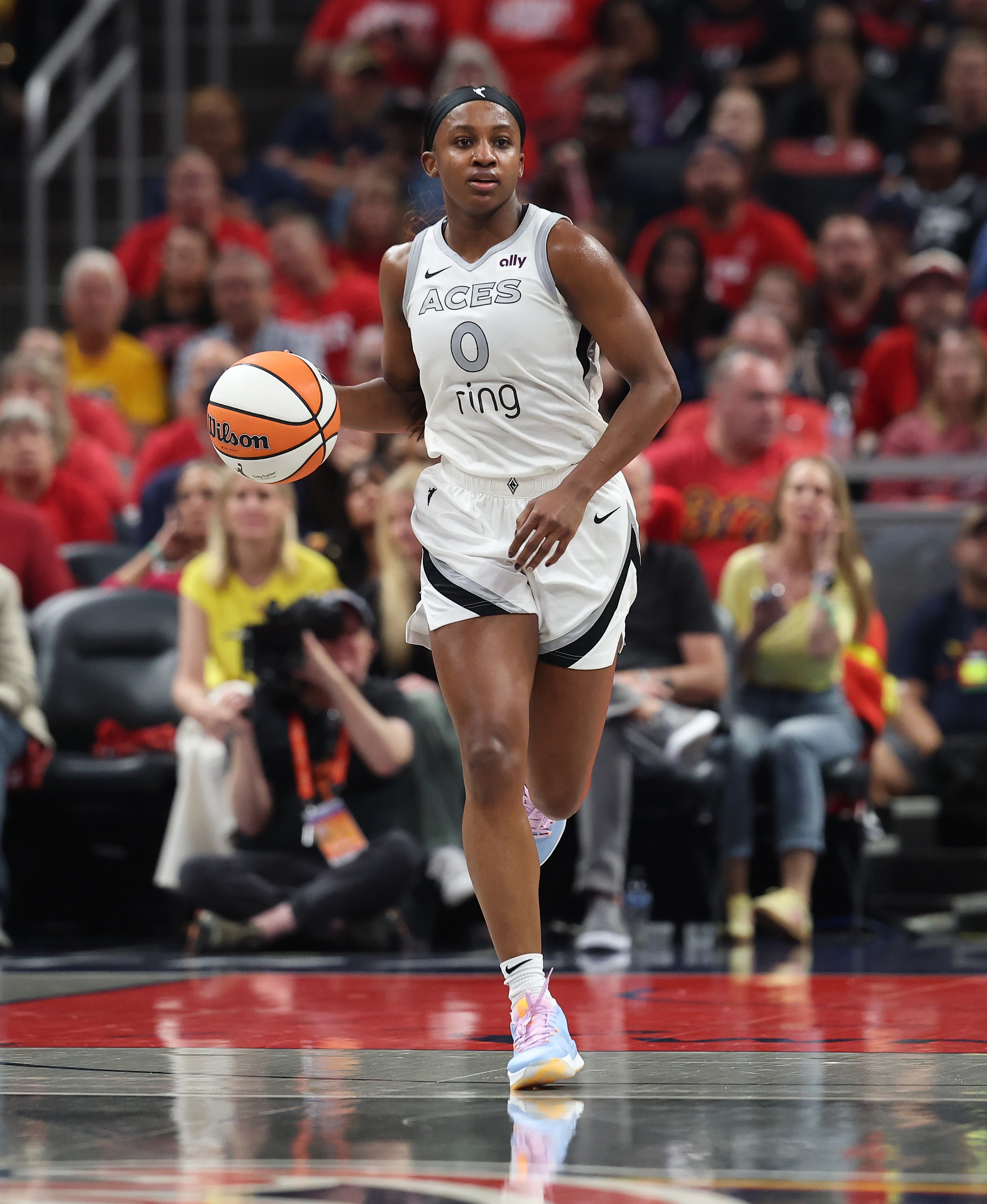 ackie Young #0 of the Las Vegas Aces dribbles the ball against the Indiana Fever