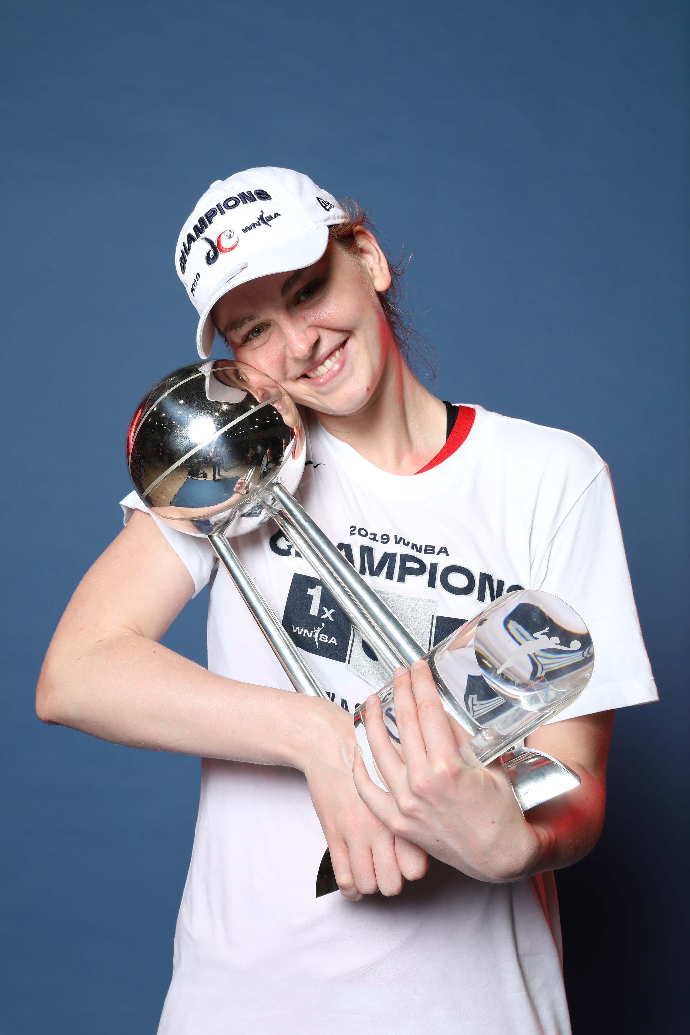 Emma Meesseman #33 of Washington Mystics smiles with the finals trophy after winning Game Five of the 2019 WNBA Finals