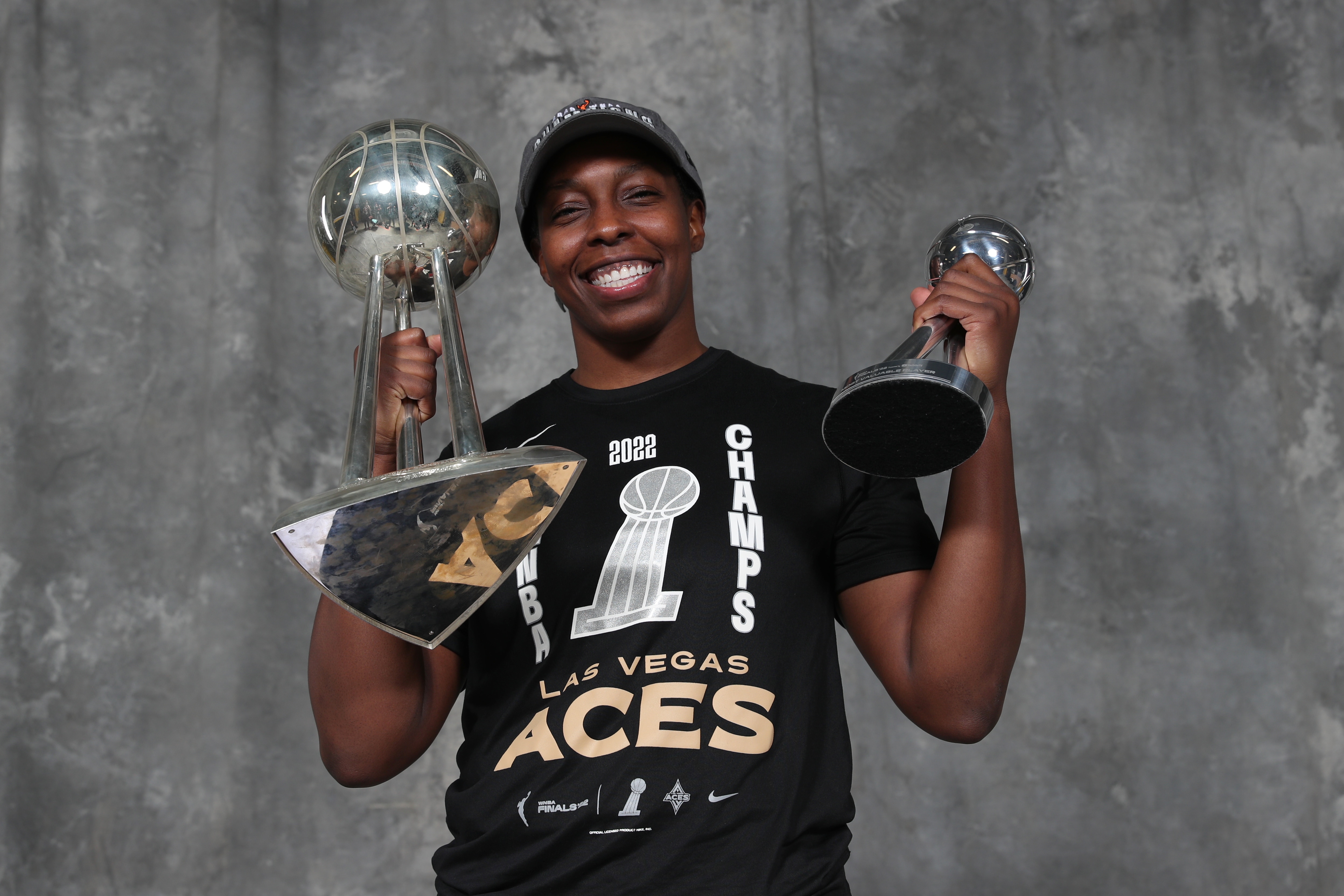 Chelsea Gray #12 of the Las Vegas Aces poses for a portrait with the 2022 WNBA Championship and MVP trophies after Game 4 of the 2022 WNBA Finals